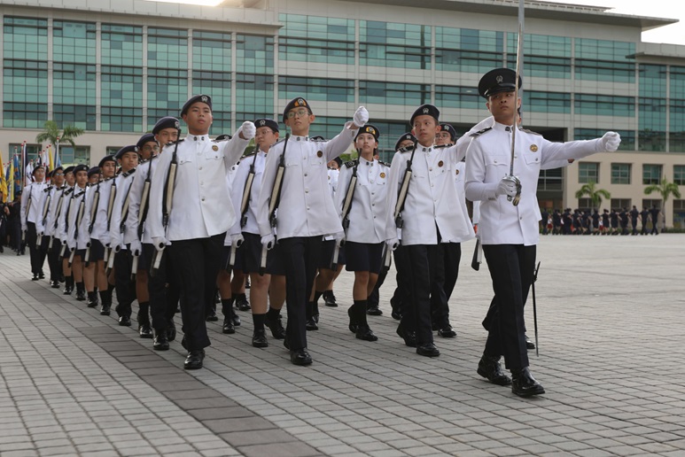 A group of people in uniform marching