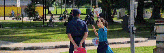 An animated image of a student crossing the road at Road Safety Community Park.