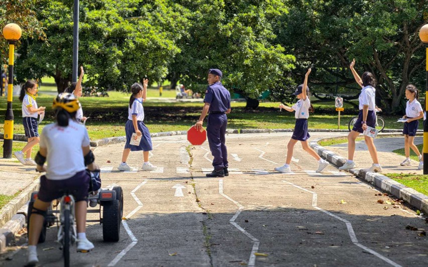 Students crossing the road at Road Safety Community Park