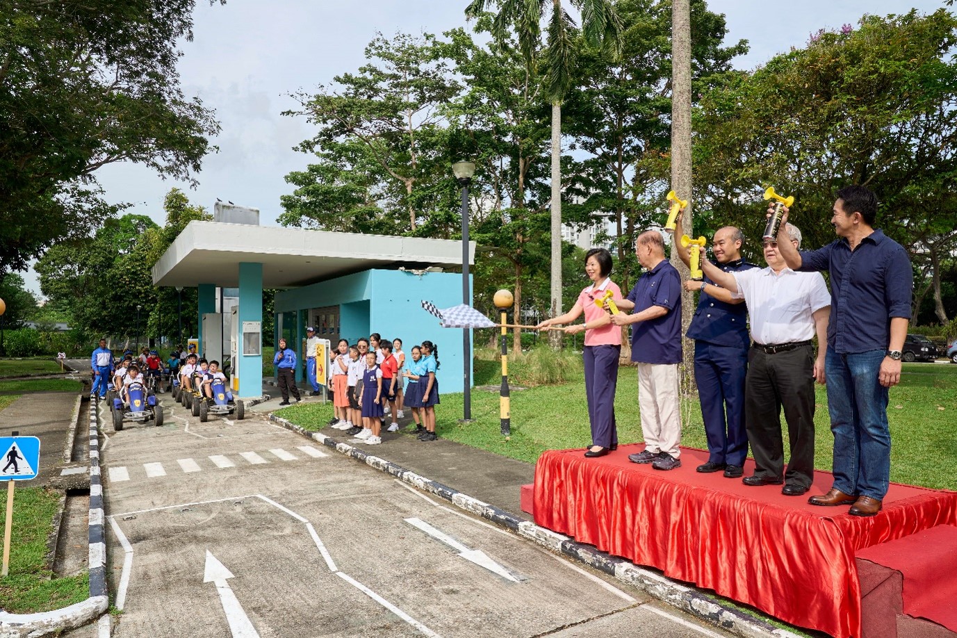 Students driving and riding in a convoy at the Traffic Games Finale, graced by Second Minister for Foreign Affairs and Home Affairs, Ms. Sim Ann, and representatives from SRSC, TP, AAS, and MOE.