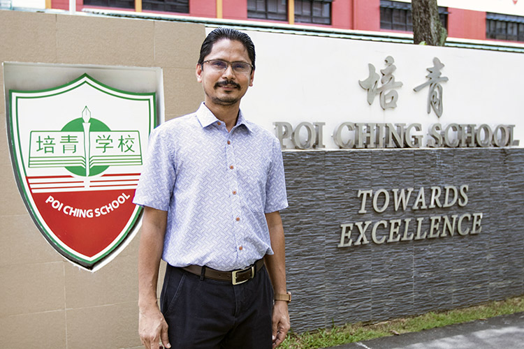 poh ching school teacher standing infront of school entrance photo