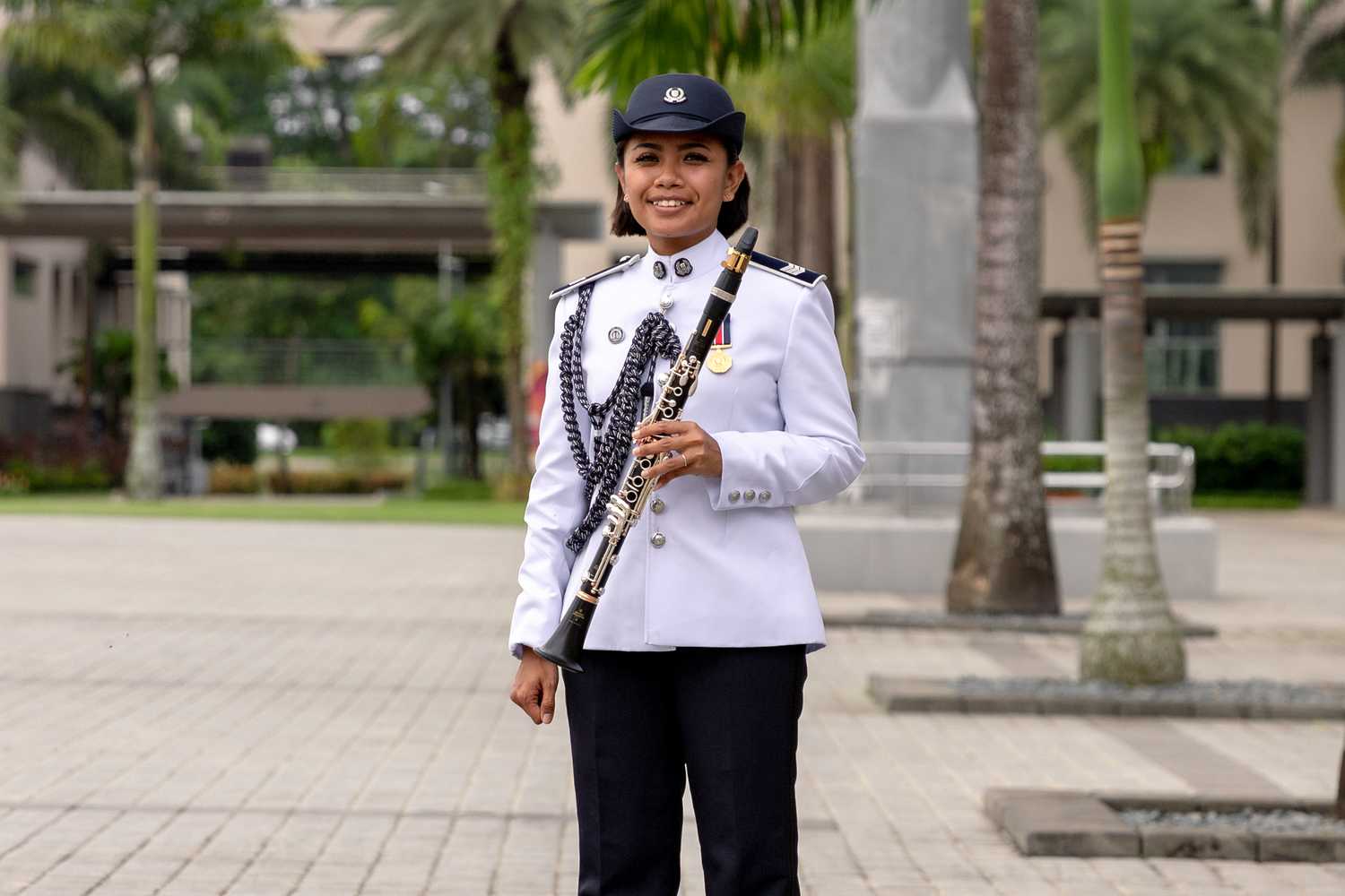 Sergeant Natassha looking straight ahead and posing with her clarinet. She is donning the SPF Band ceremonial uniform like her father. 