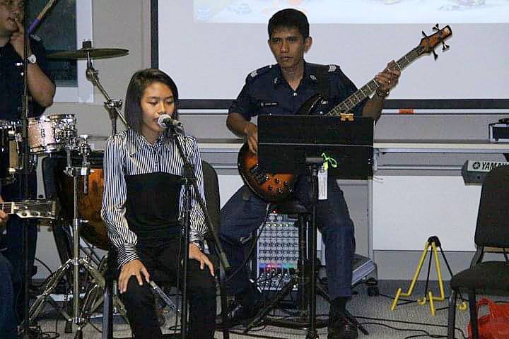 Senior Inspector Julaimi performing with Sergeant Natassha a few years back, Senior Inspector Julaimi wearing the SPF number 3 uniform, Sergeant Natassha wearing civilian clothing.