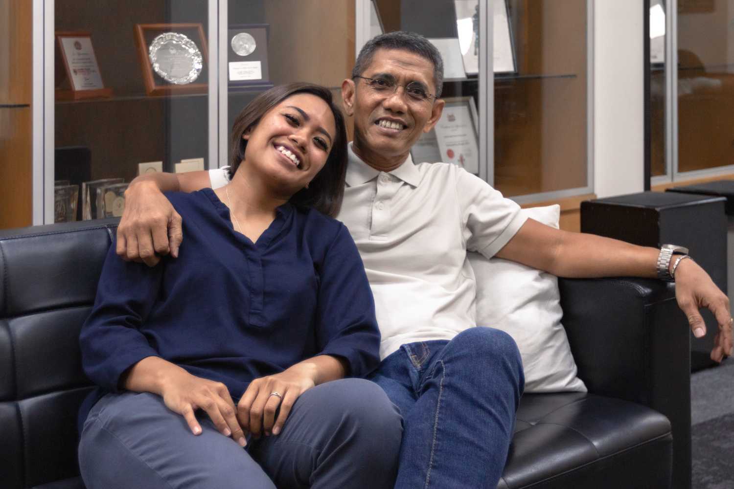 Senior Inspector and Sergeant Natassha wearing civilian clothing, posing for the camera together and smiling widely.