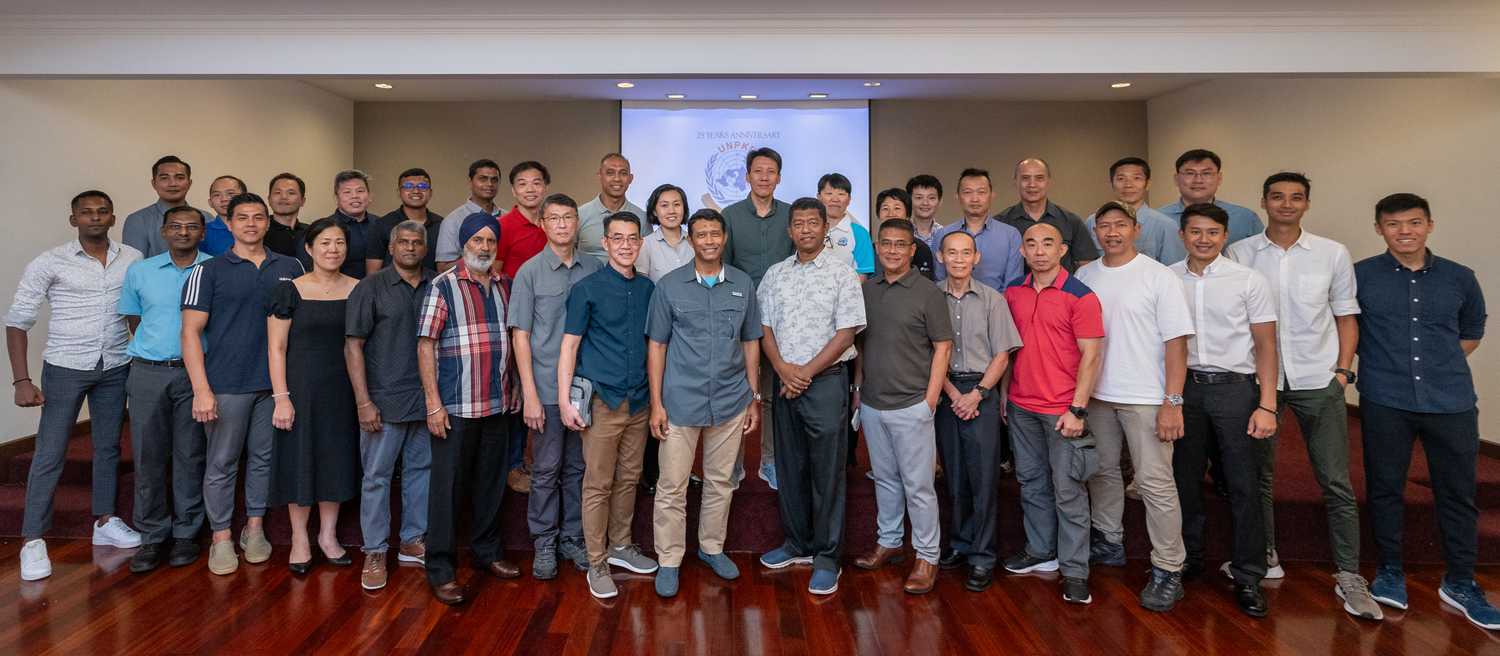 group of people standing together and posing for camera