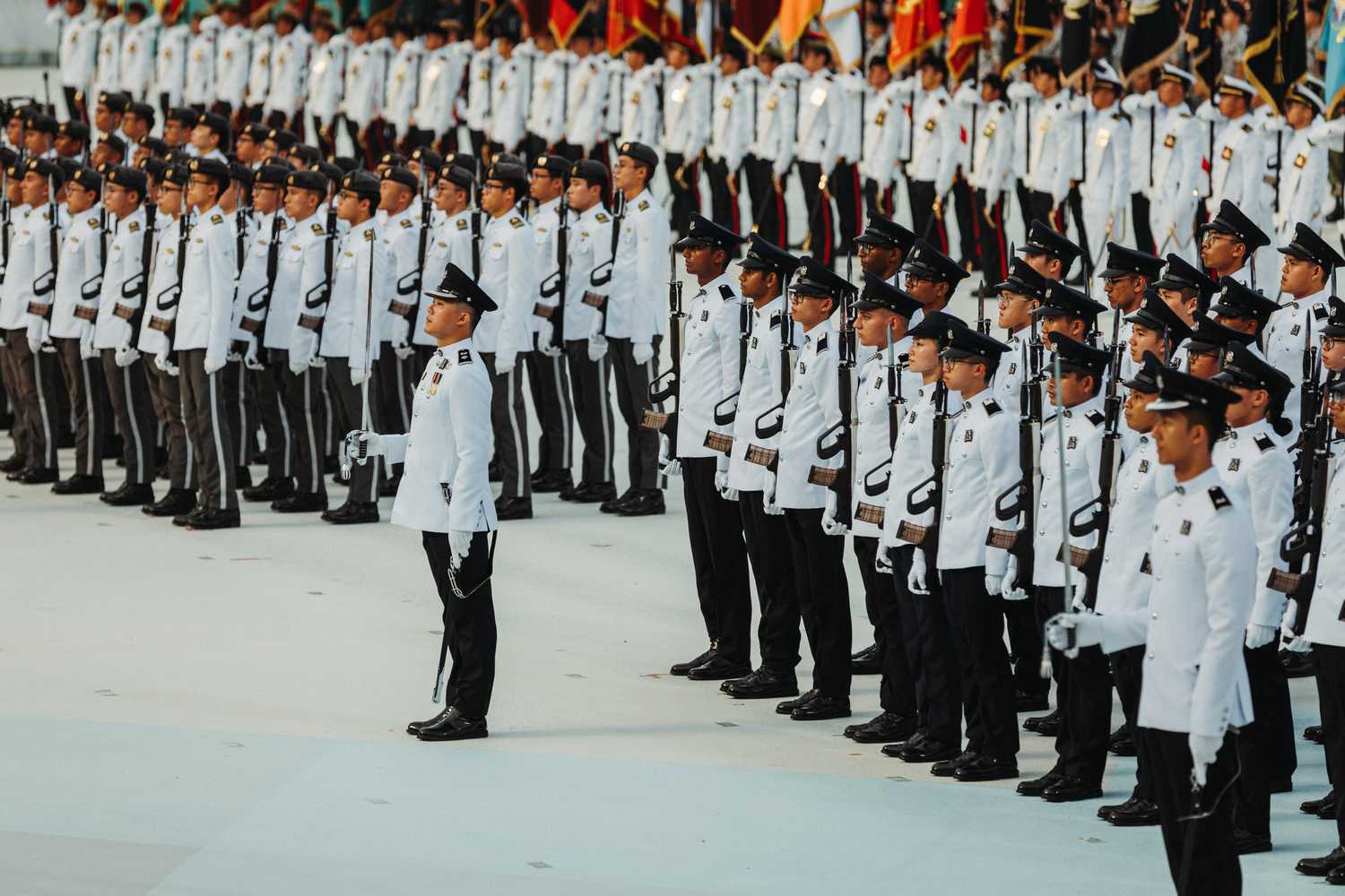 The SPF and SAF guard-of-honor contingents stand in attention with their SAR21 rifles. The officers look focused as they await their commands for salute.