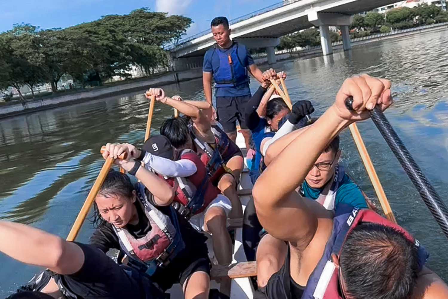 Sergeant Ivie and her team mates paddling a dragon boat during a training session. 