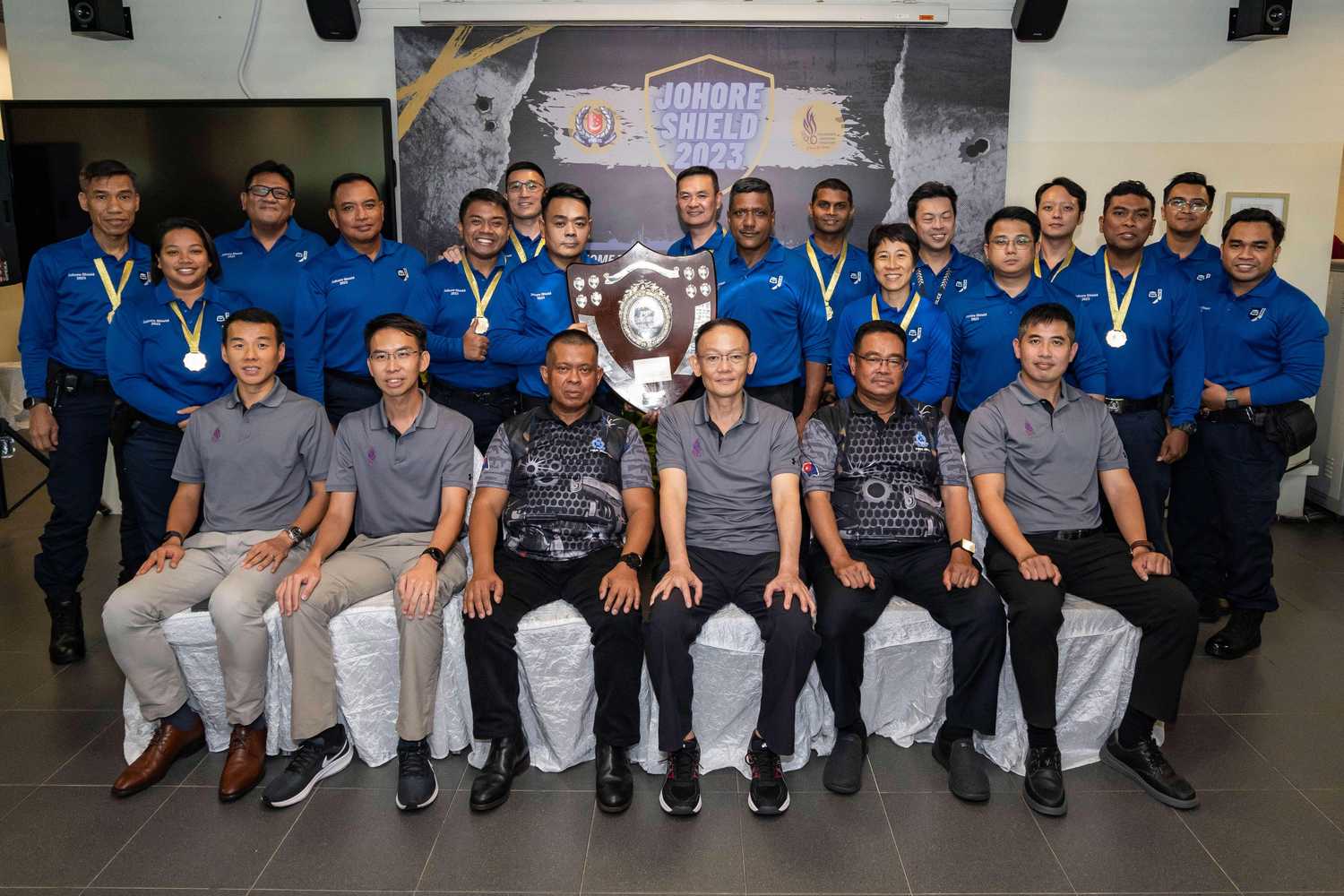 ground photo of all competition participants, with commissioner of police in the centre front row