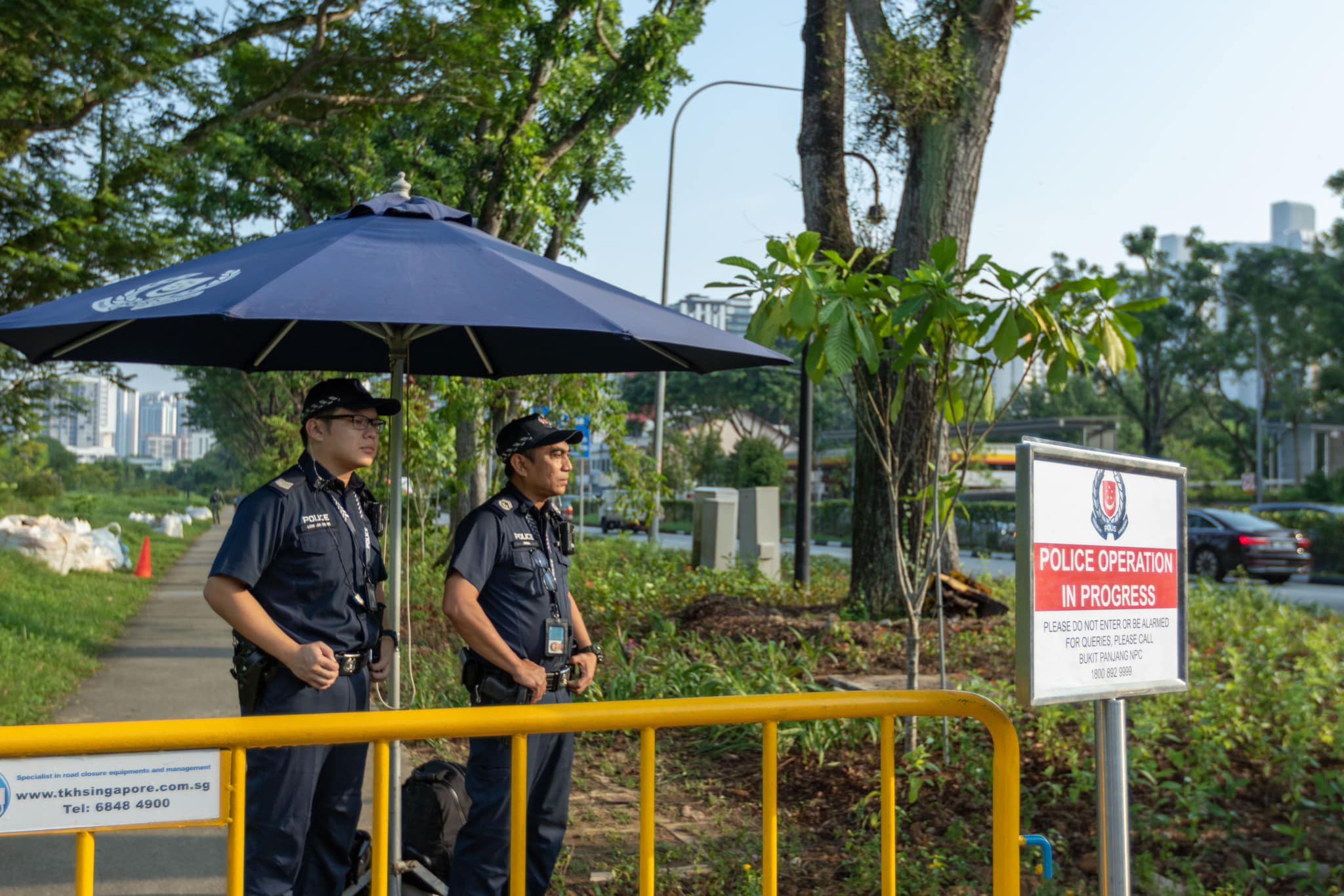 Two uniformed officers are on alert and stationed near the cordon on the outskirts of the bomb disposal exercise.