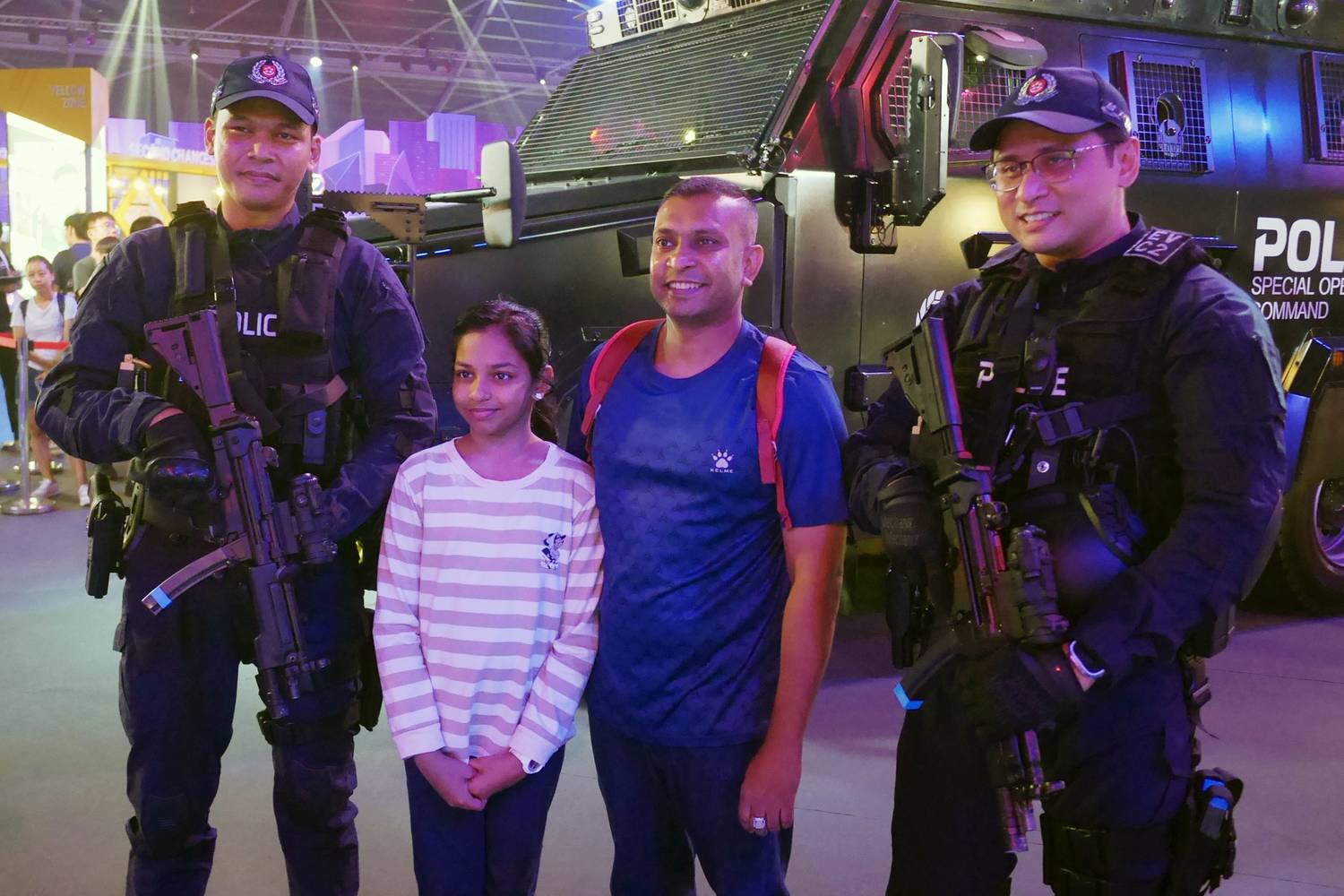 members of the public posing with two ERT officers