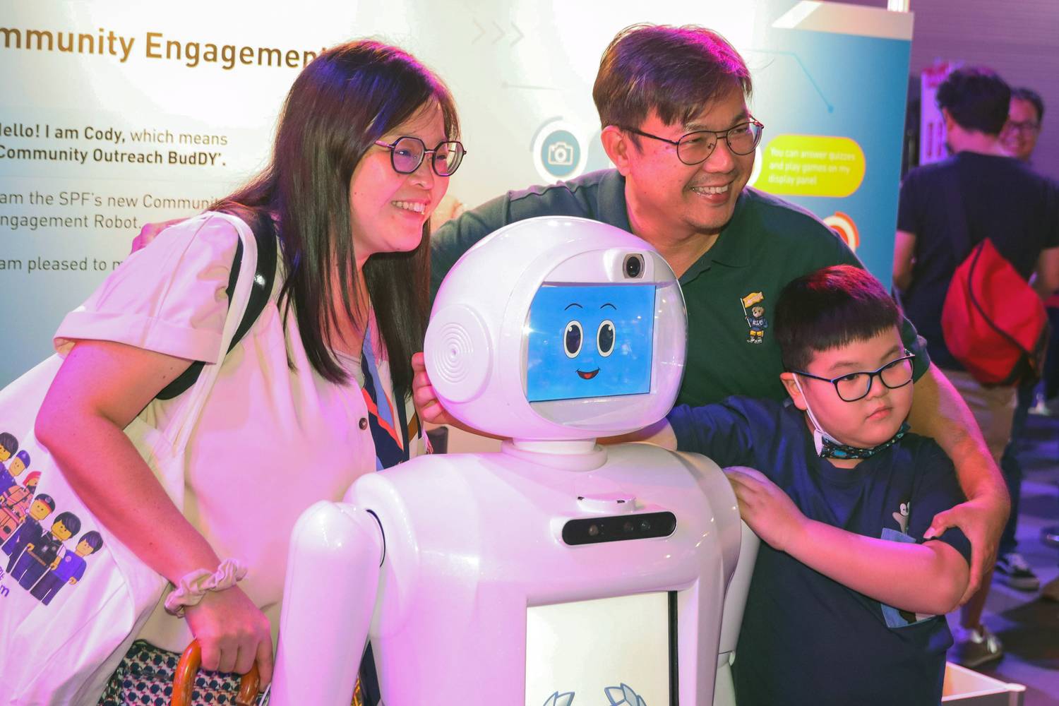 a family posing together with the robot