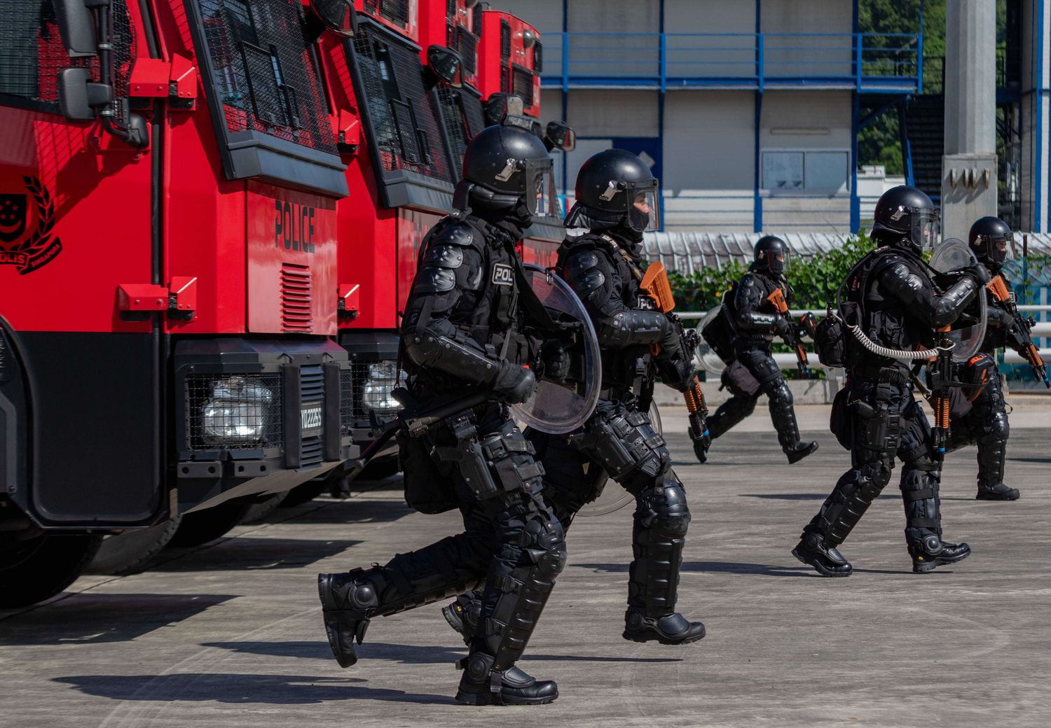 SOC troopers dashing towards the right from their red tactical vehicle