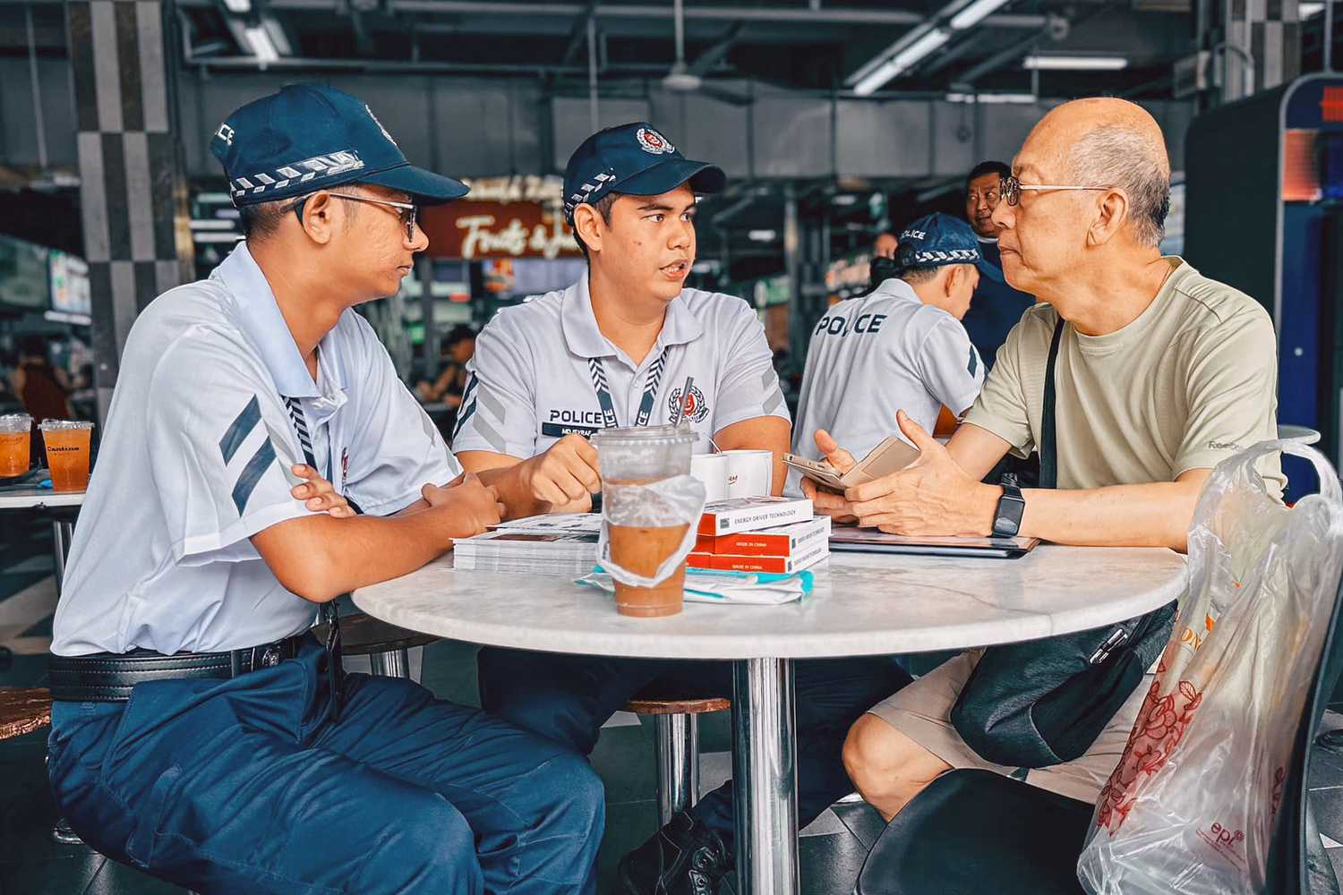 Two officers chatting with a member of public.