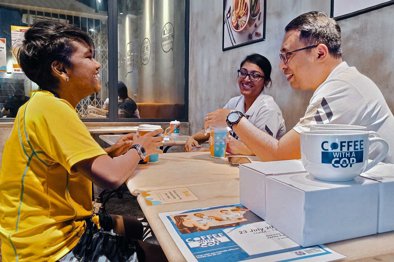 Two officers having a chat with Toa Payoh NPC resident.