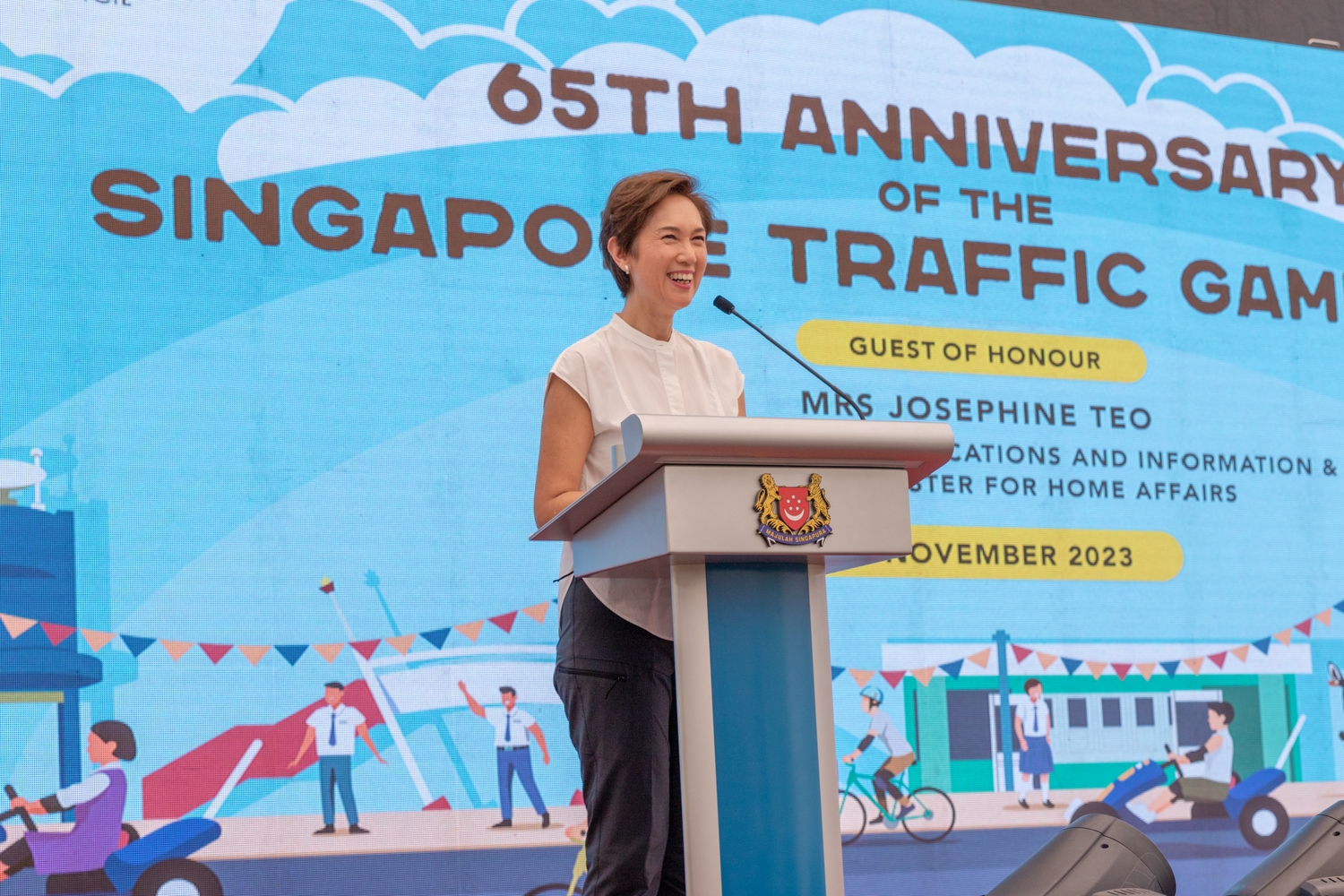 Mrs Josephine Teo, Minister for Communications and Information & Second Minister for Home Affairs, stands on a podium to give an opening speech during the 65th anniversary of the singapore traffic games.