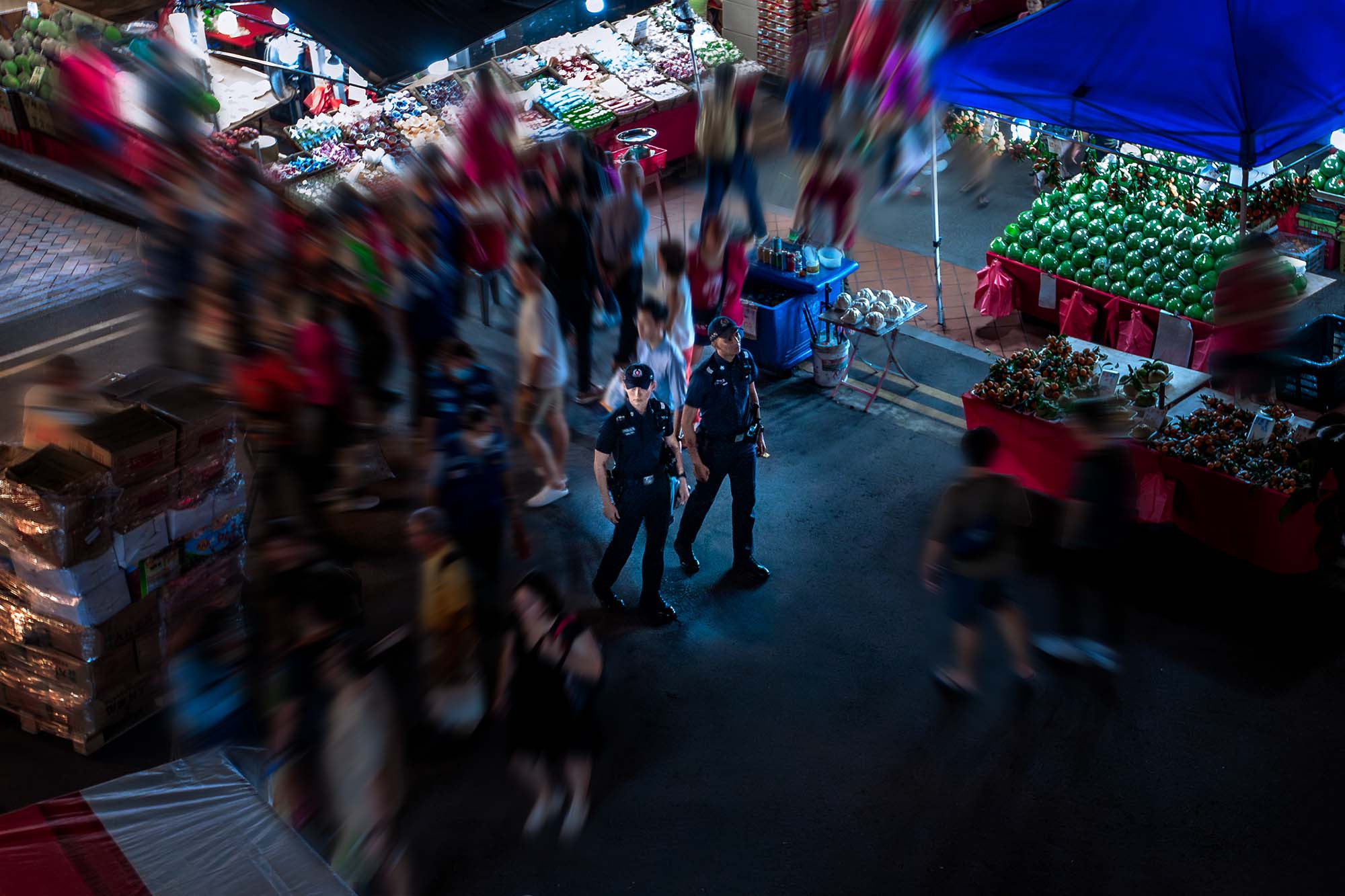 an aerial shot of the two officers walking among the crowd, with the photo blurred to keep only the officers in focus