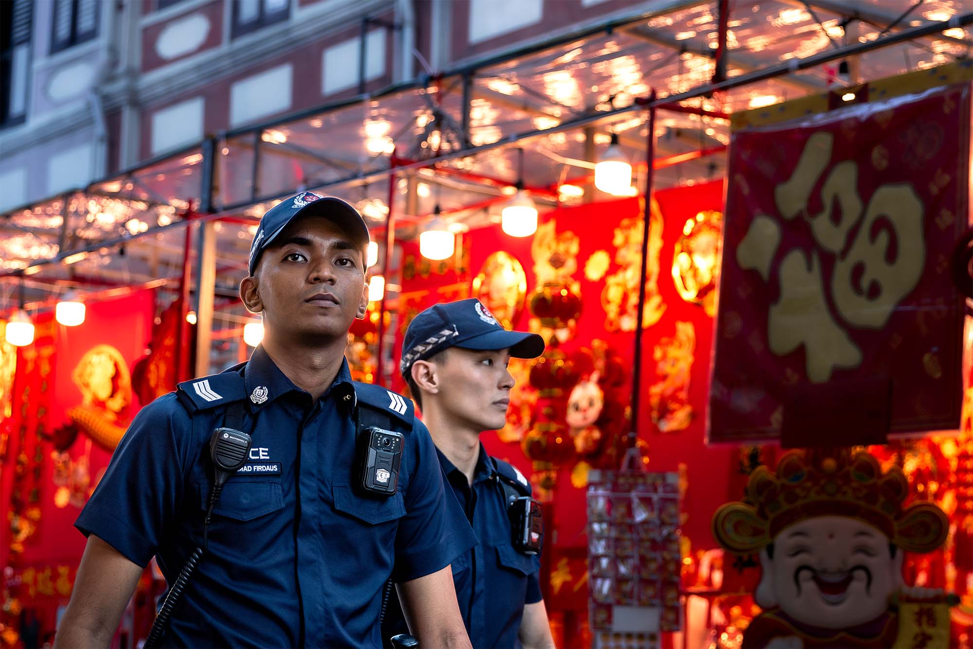 officers patrolling with chinese red lanterns in the background