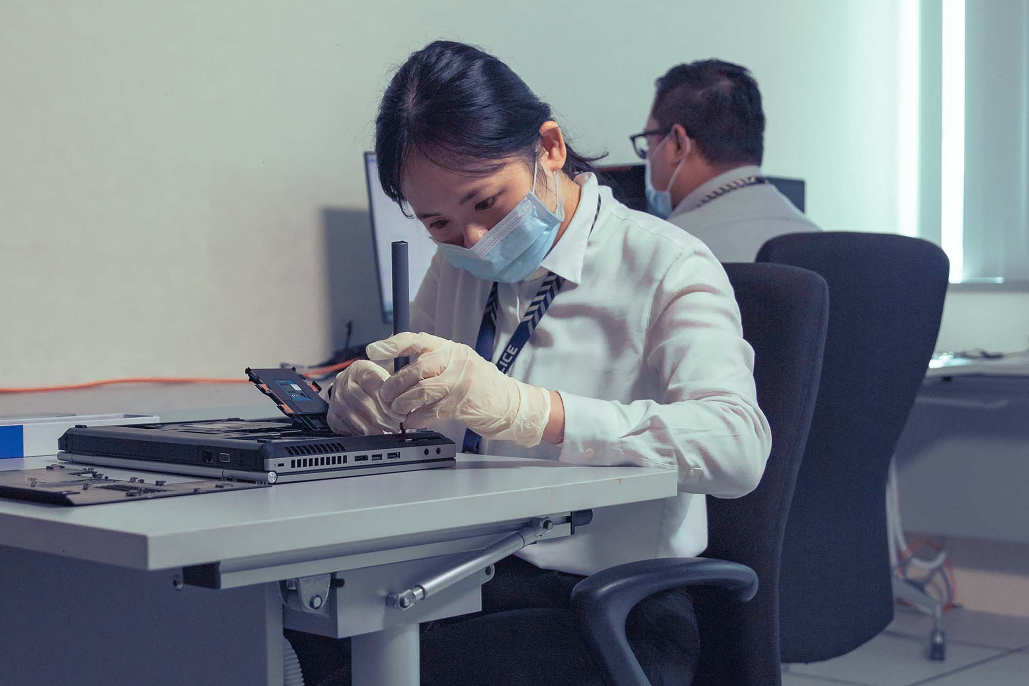 A re-enactment of officers examining Ho’s storage devices as part of their investigations. PHOTO: SPF