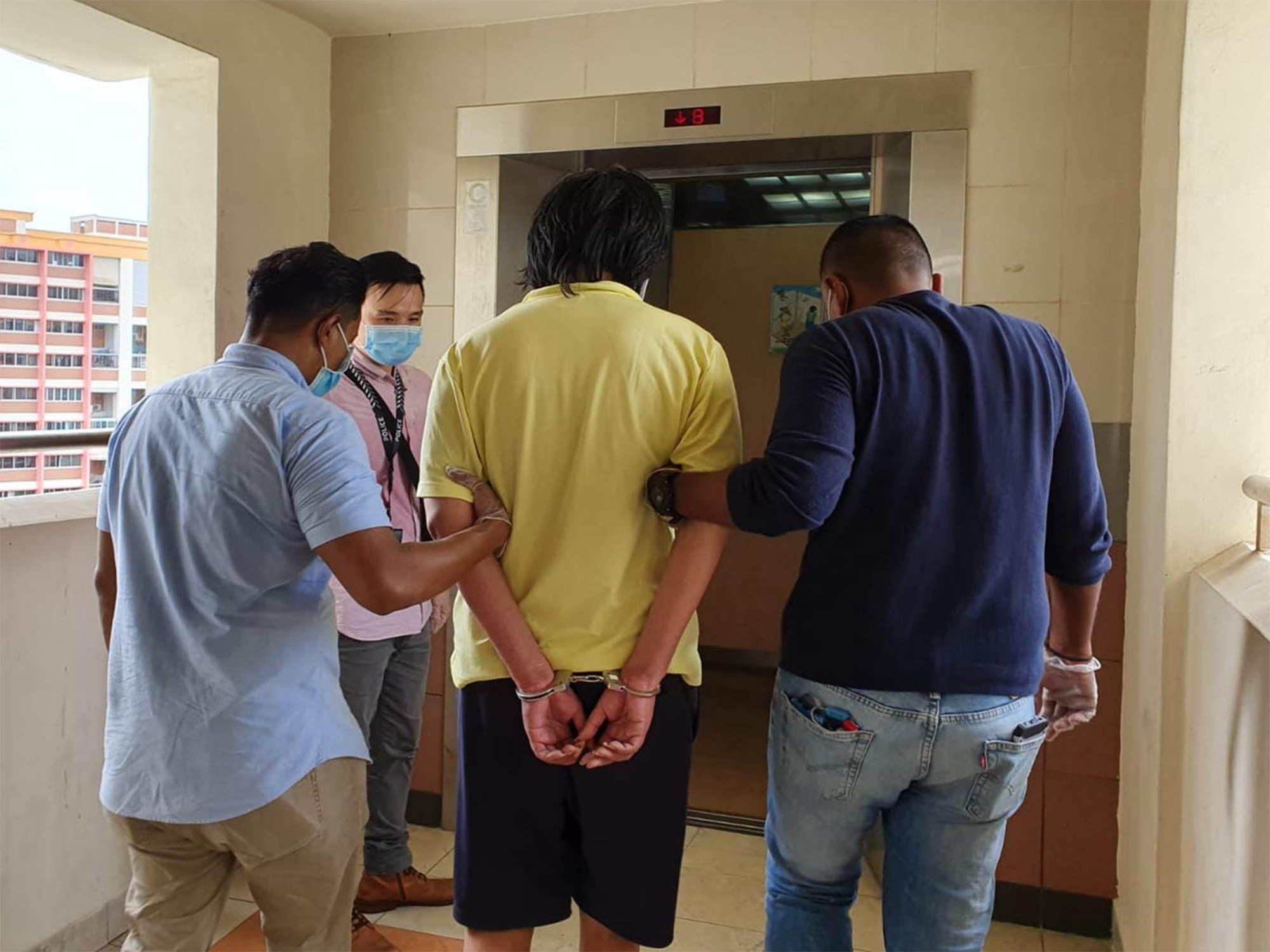 Poh being escorted back for investigations. PHOTO: SPF