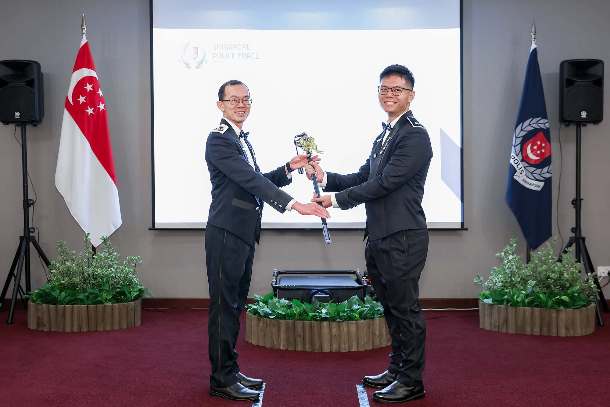 Receiving my Ceremonial Sword of Honour from the Guest of Honour, Deputy Commissioner of Police (Operations) Lian Ghim Hua. PHOTO: SPF