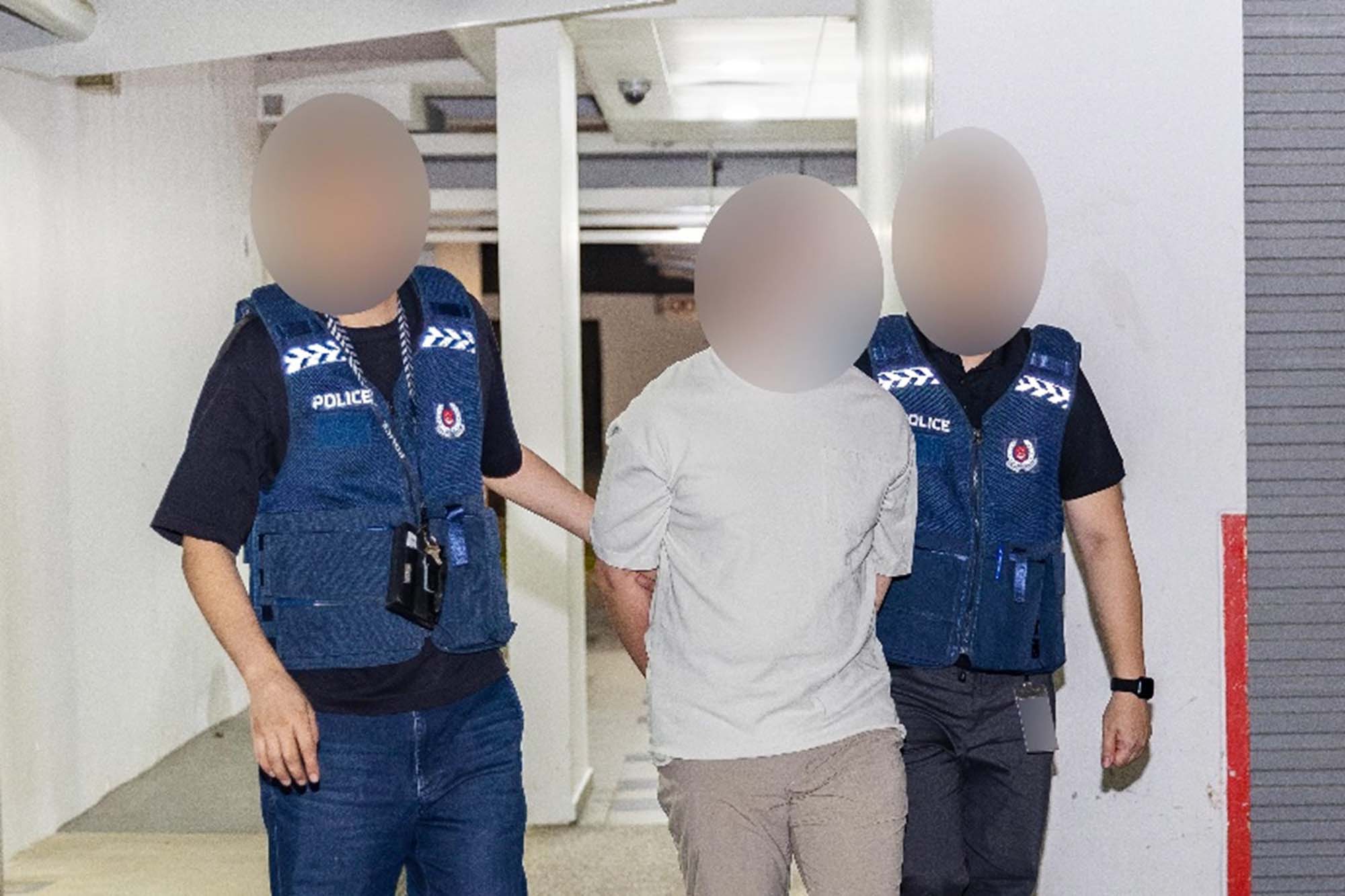 spf officers arresting and escorting a person to the police van 