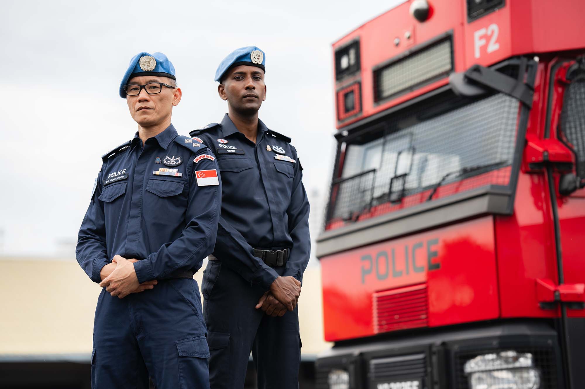 two officers standing infront of an SOC vehicle