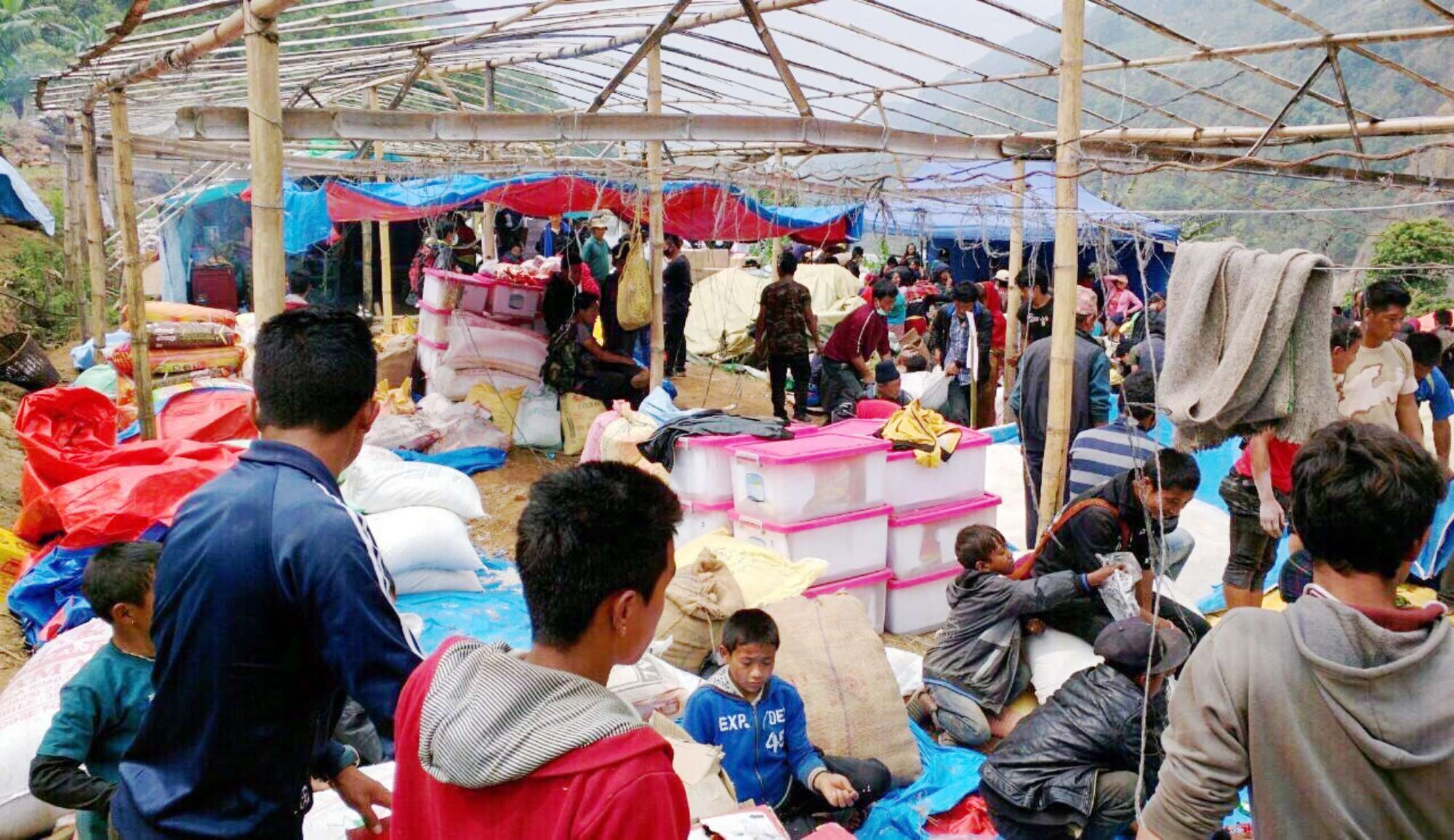 a picture of a makeshift shelter where supplies and goods were being provided