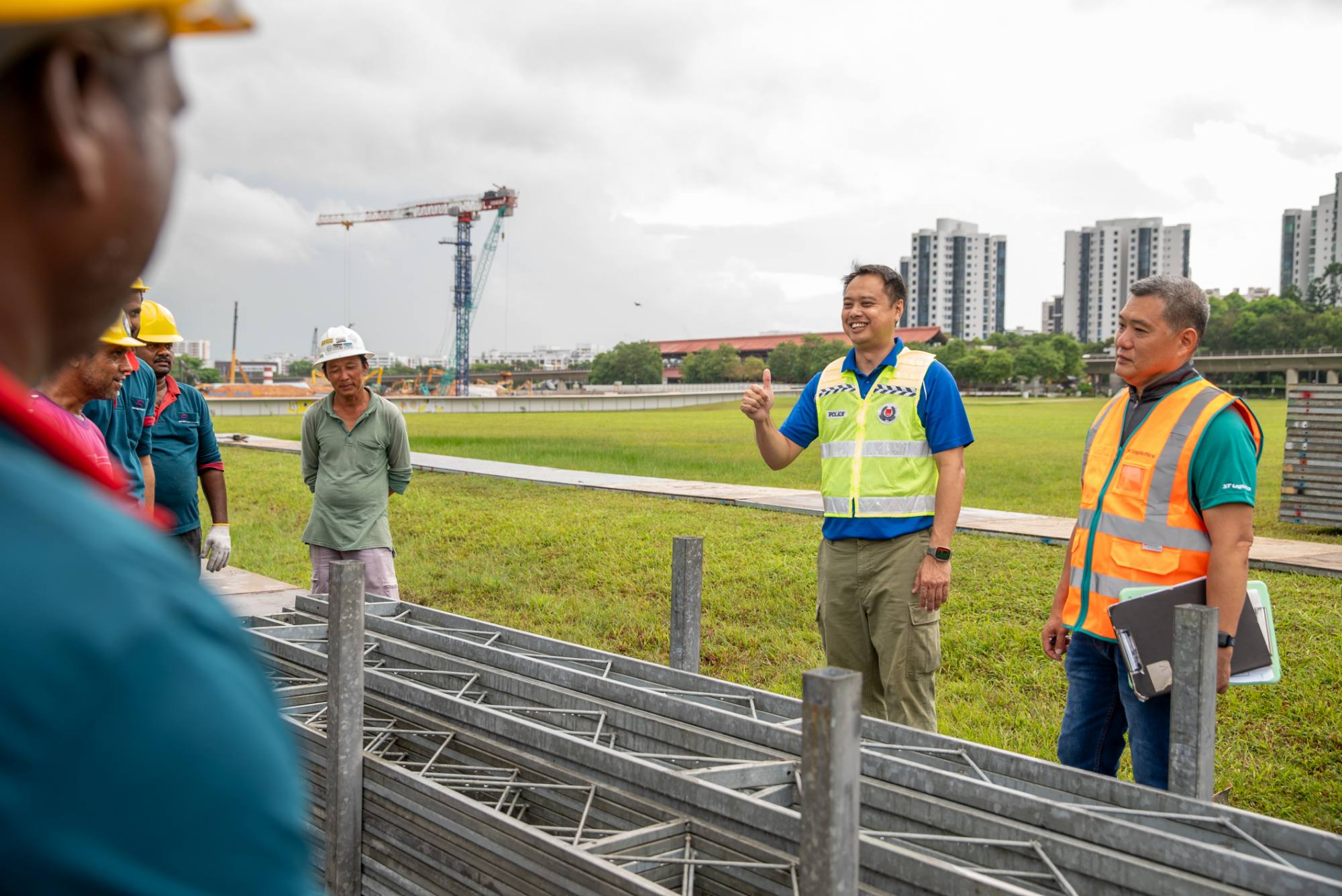pld officer at a field talking to workers