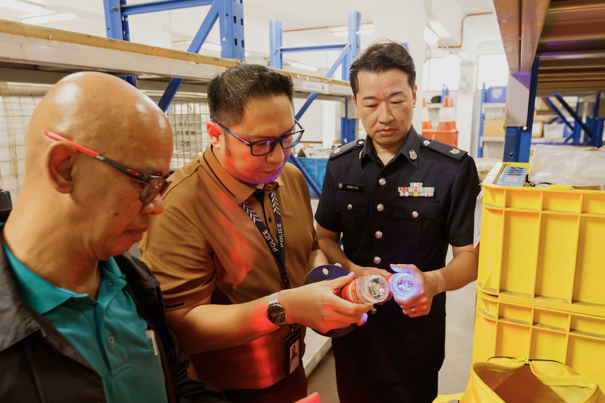 officers at a warehouse checking equipment with the staff