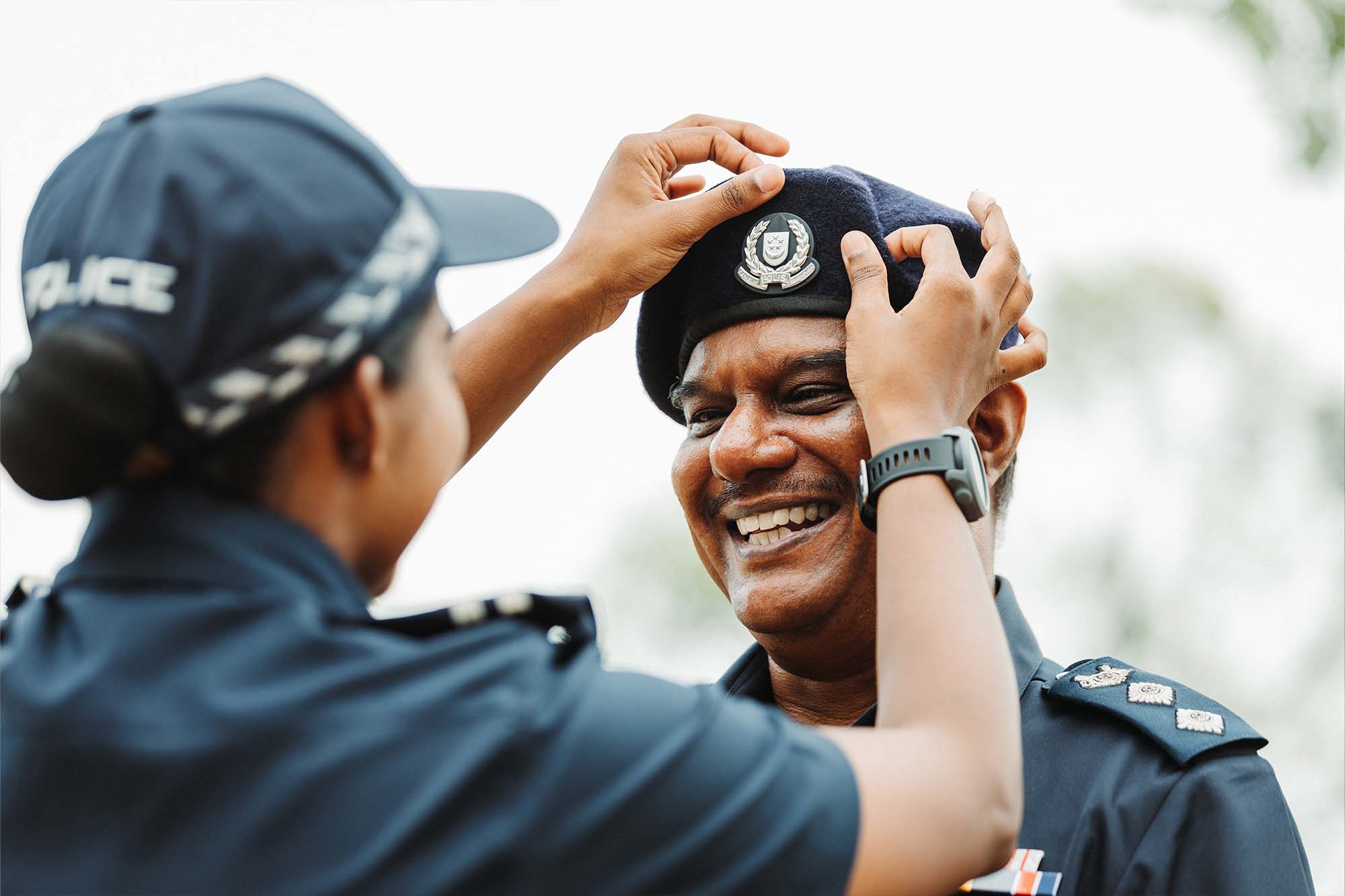 tharani is seen adjusting her father's beret