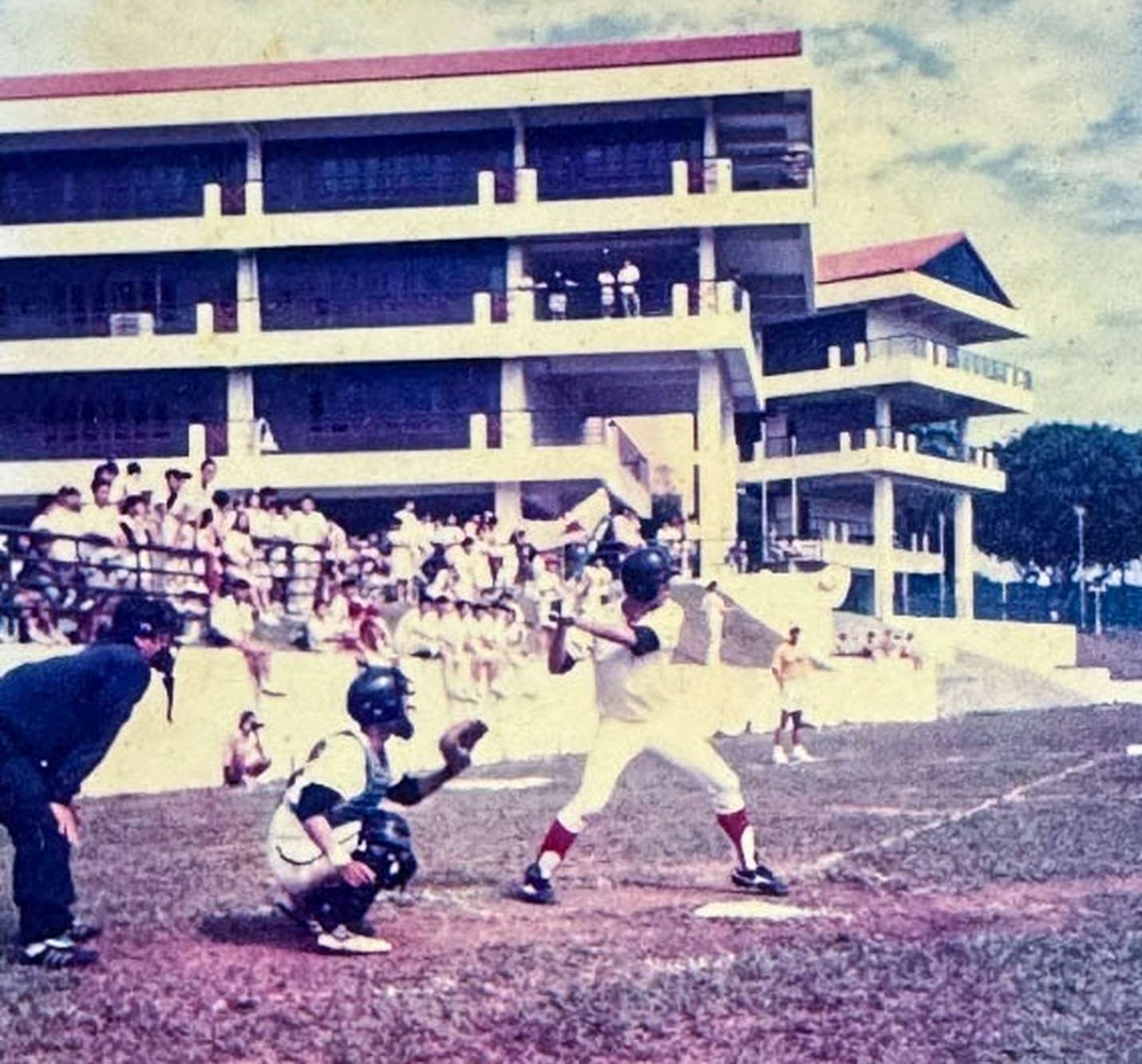 an old photo of a batter hitting a softball during a match