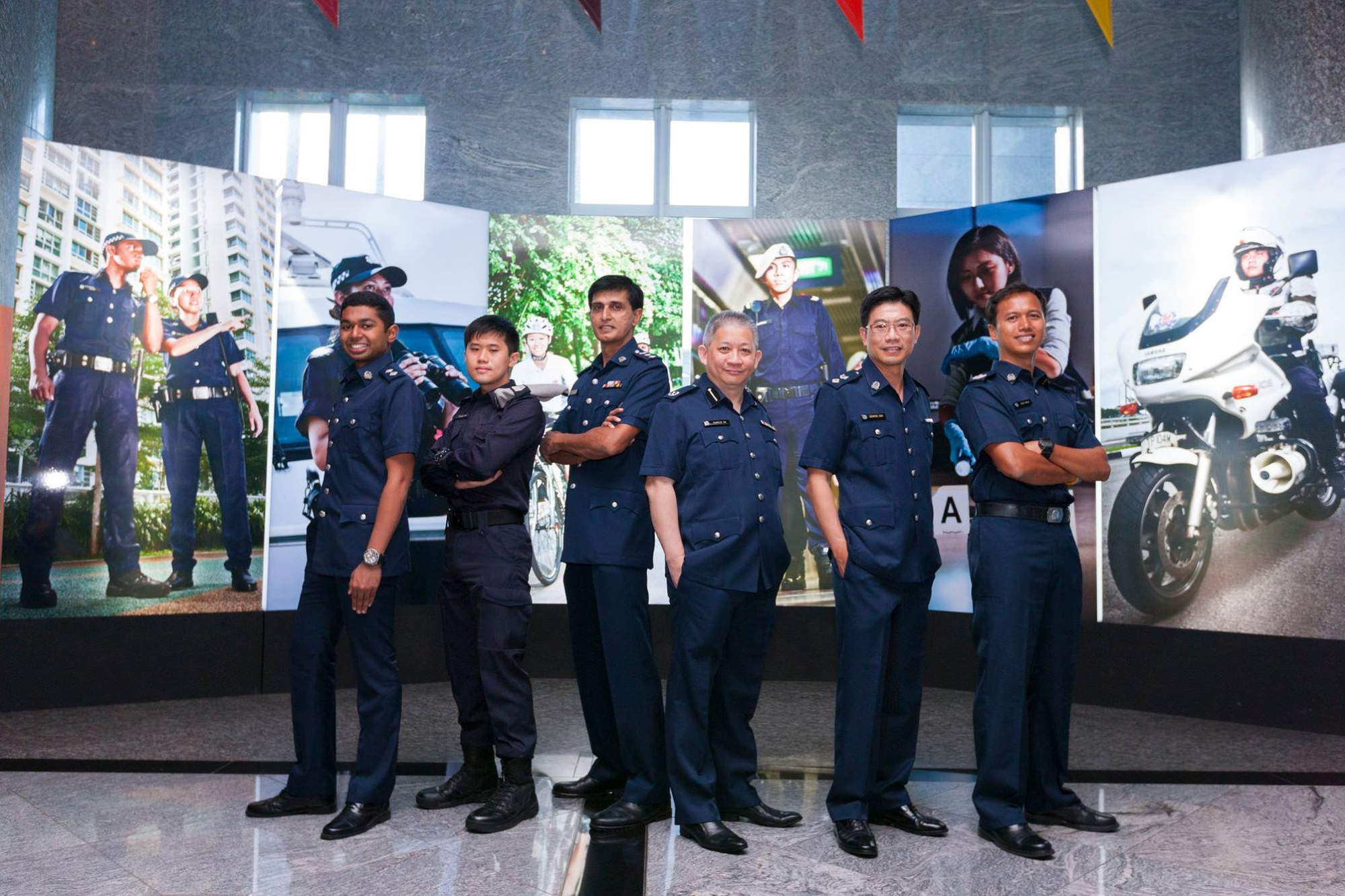 a dated photo of him with other award recipients posing for the camera. All are wearing their police uniform