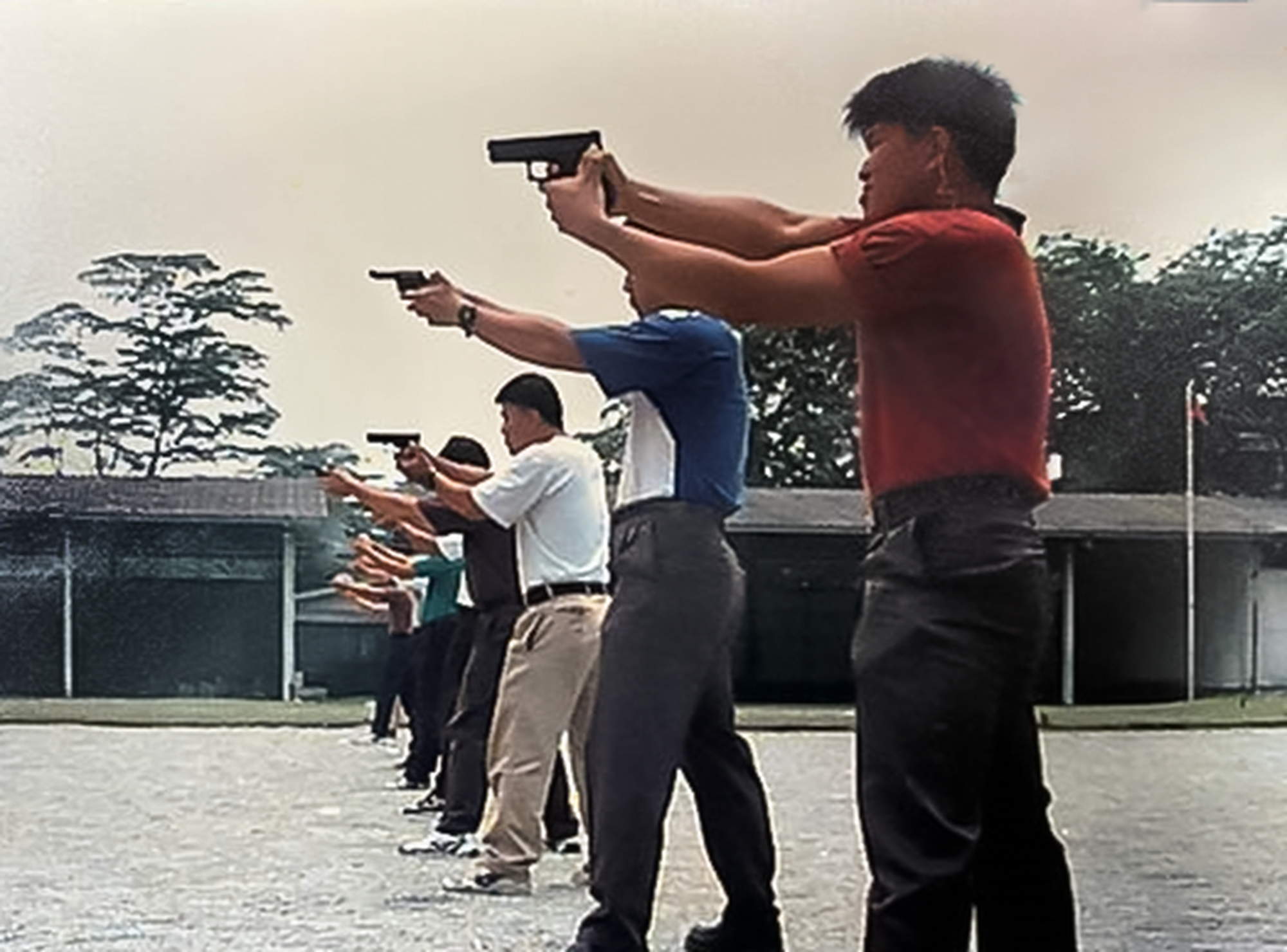 officers in civilian clothing shooting a revolver towards the left side. 