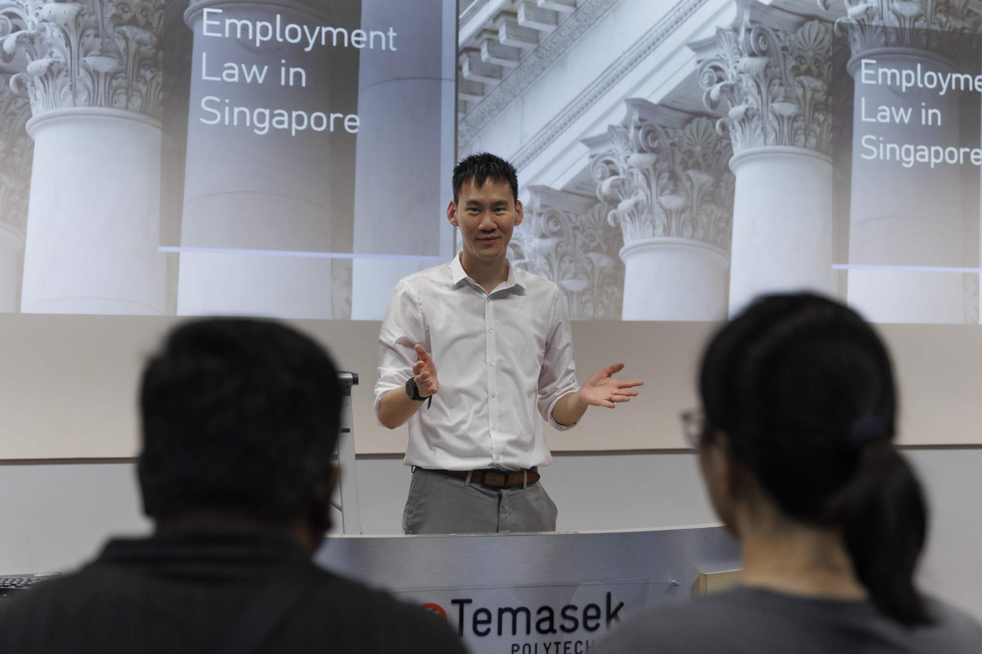jason wearing white and conducting a lecture at temasek polytechnic