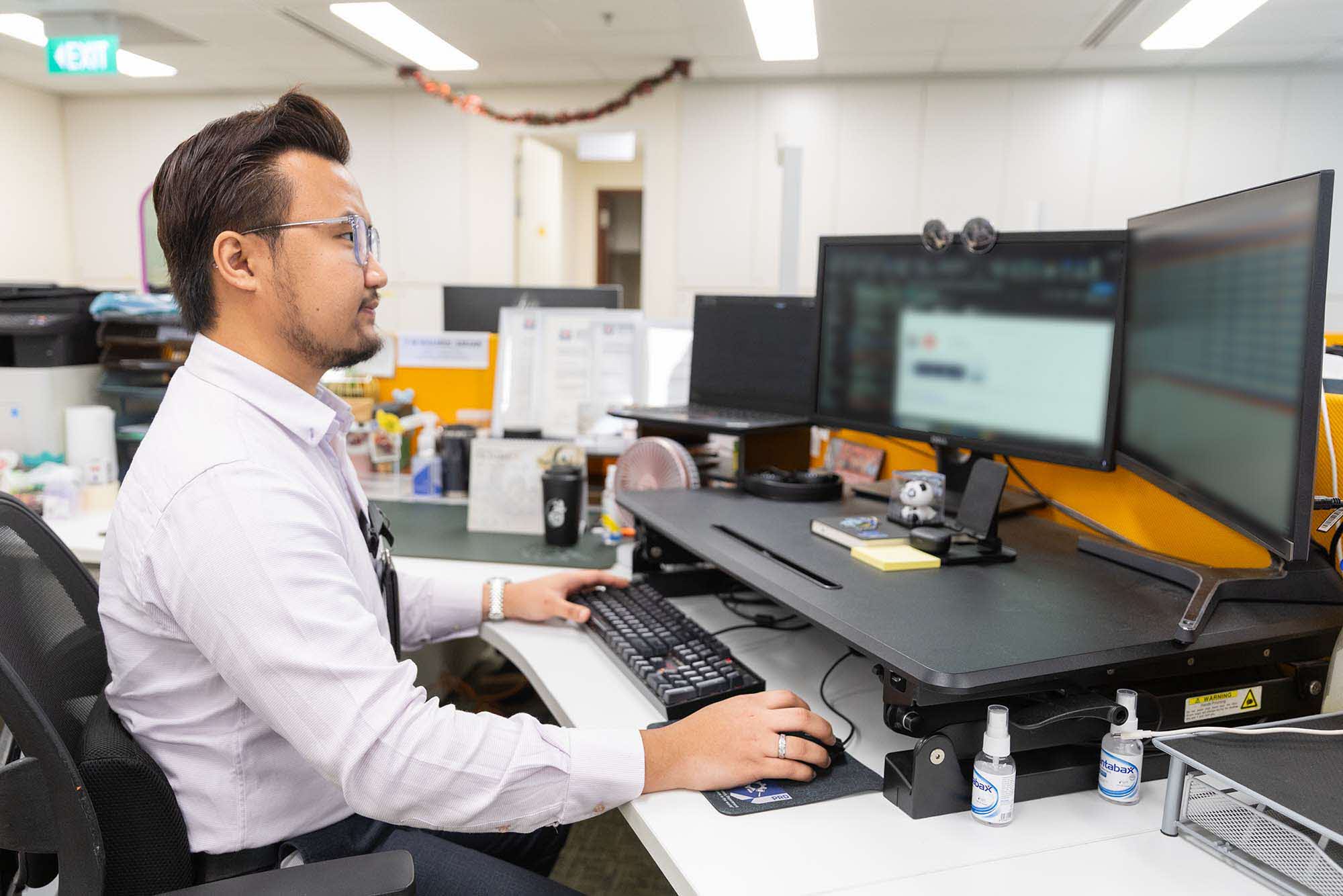Mr Khairul working at his desk.
