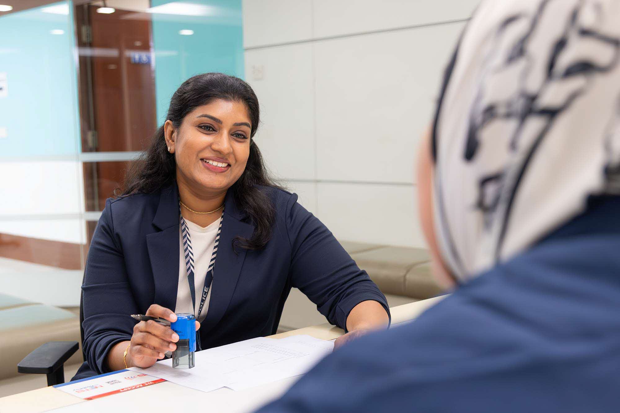 Ms Rogini speaking to her colleague at the counter.