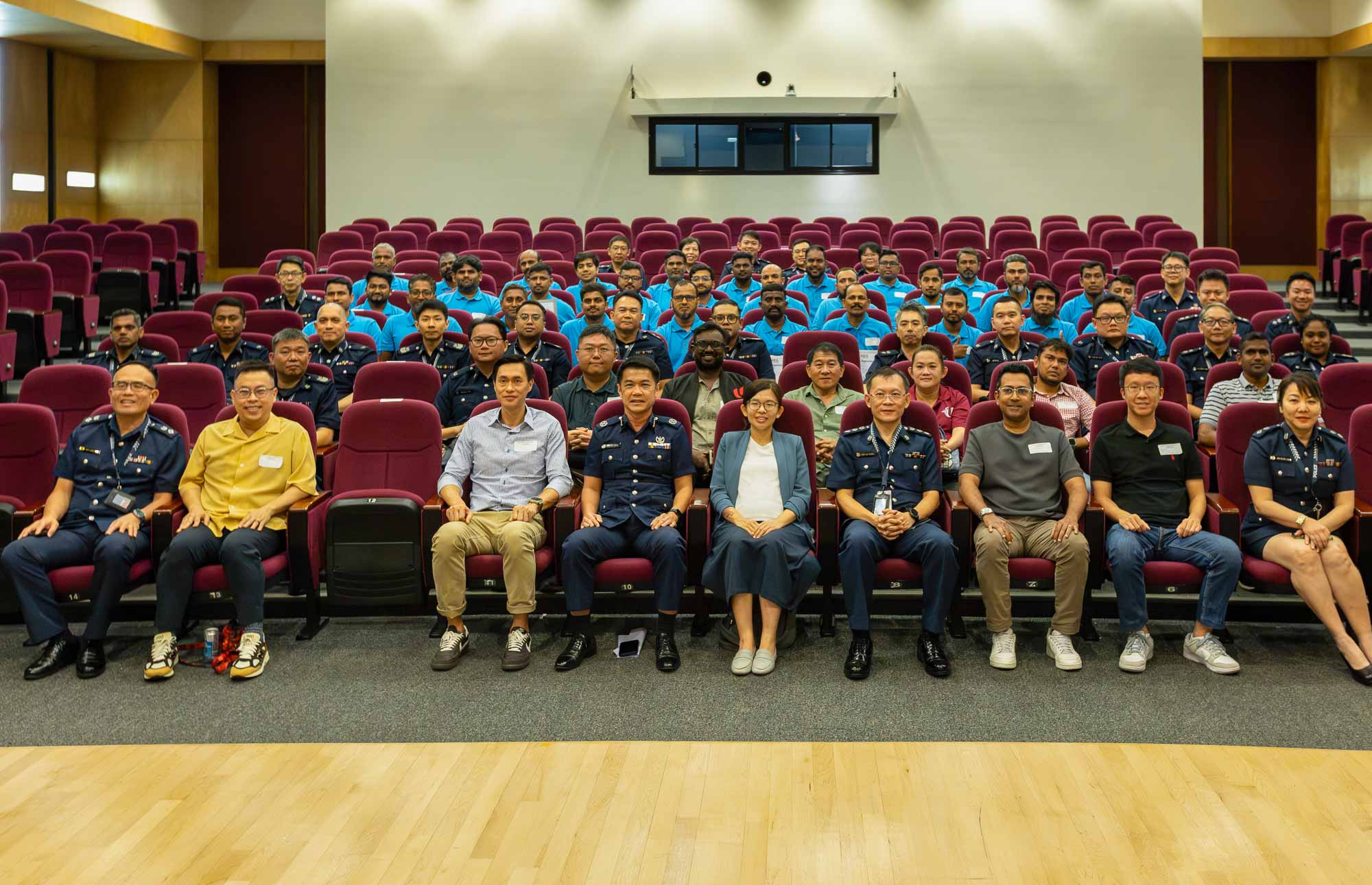A group photo of Police officers, migrant worker ambassadors and representatives from relevant agencies