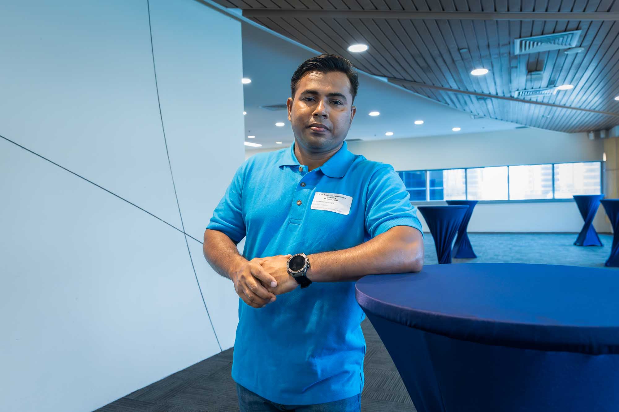 C.a.N Ambassador Abul Hossain Tuhin posing next to a table