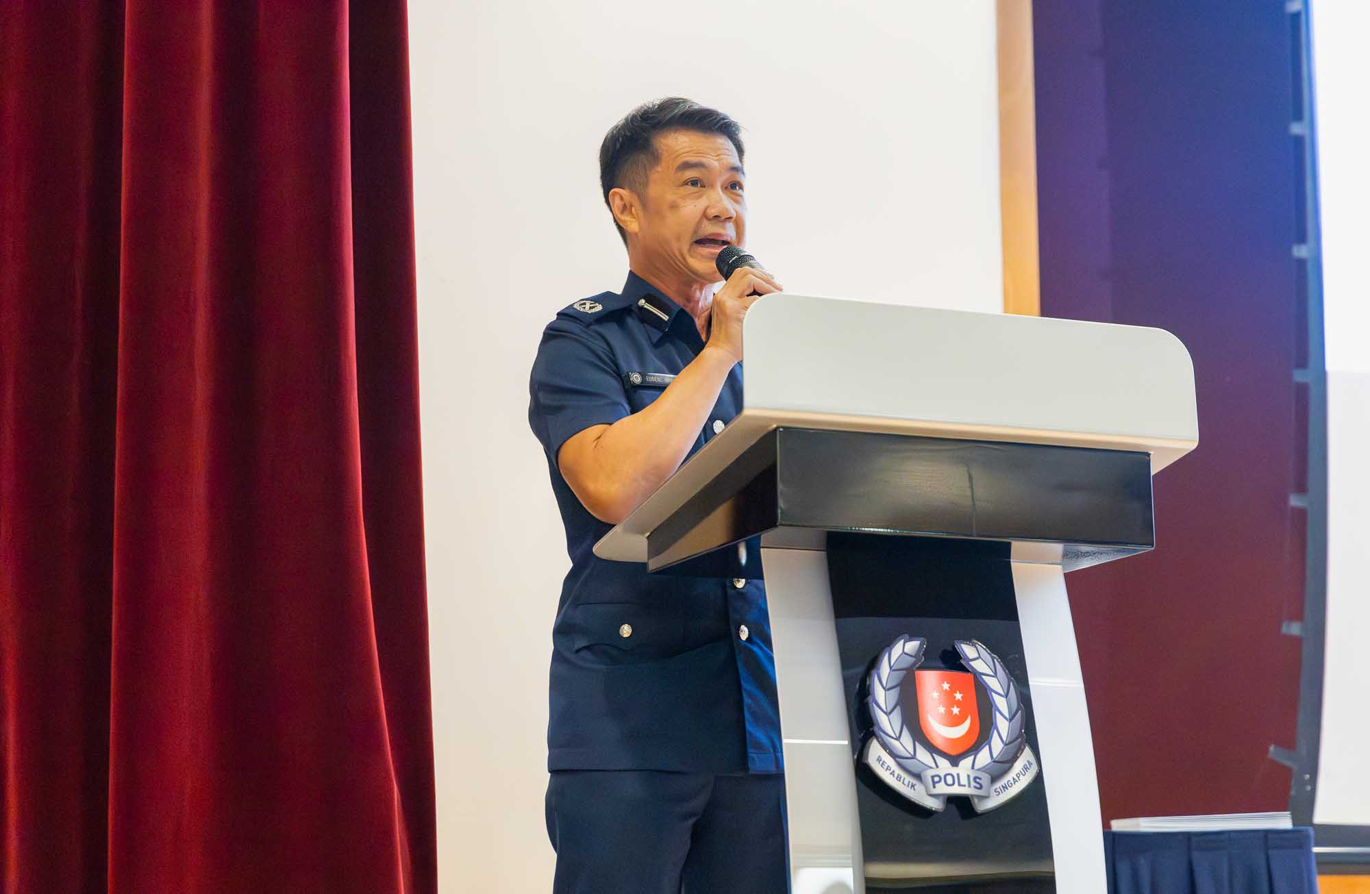 A shot of DAC Wong making a speech on the stage