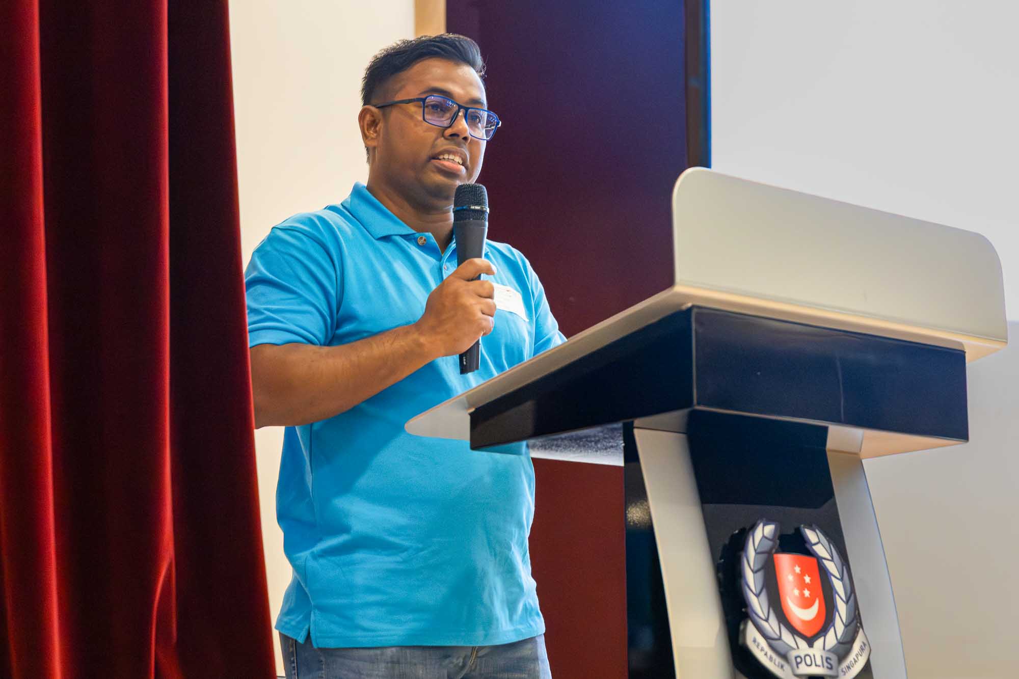 Mr Tuhin giving a speech on stage. 