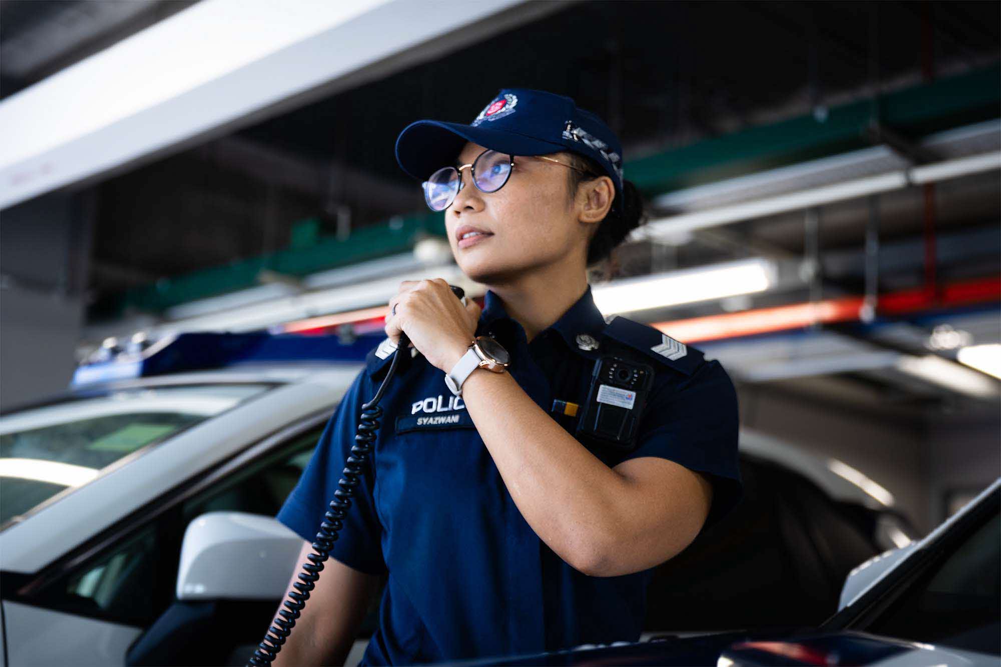 Sgt Syazwani communicating through comms set while on patrol.