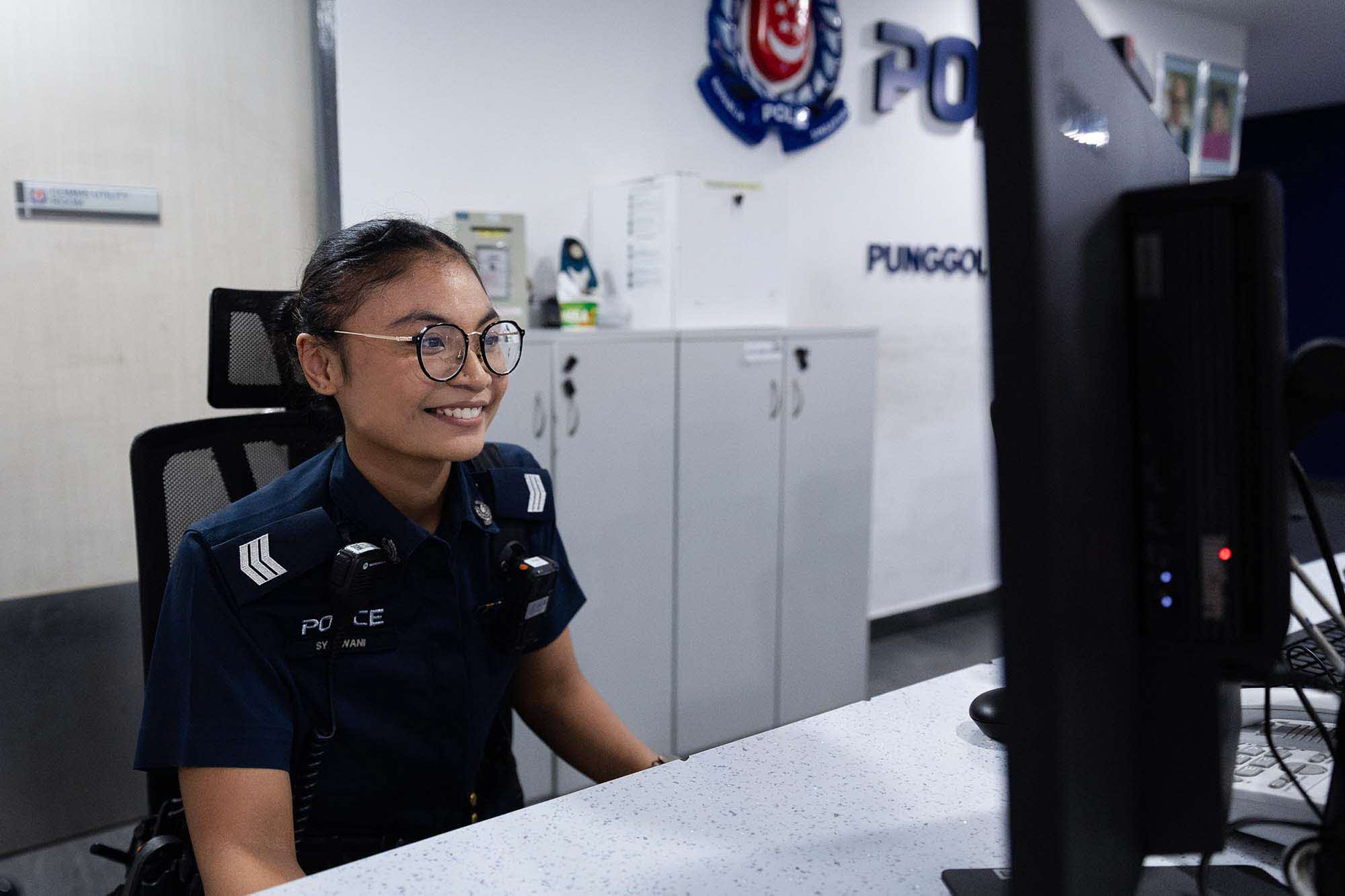 Sgt Syazwani performing counter duties at Punggol NPC.