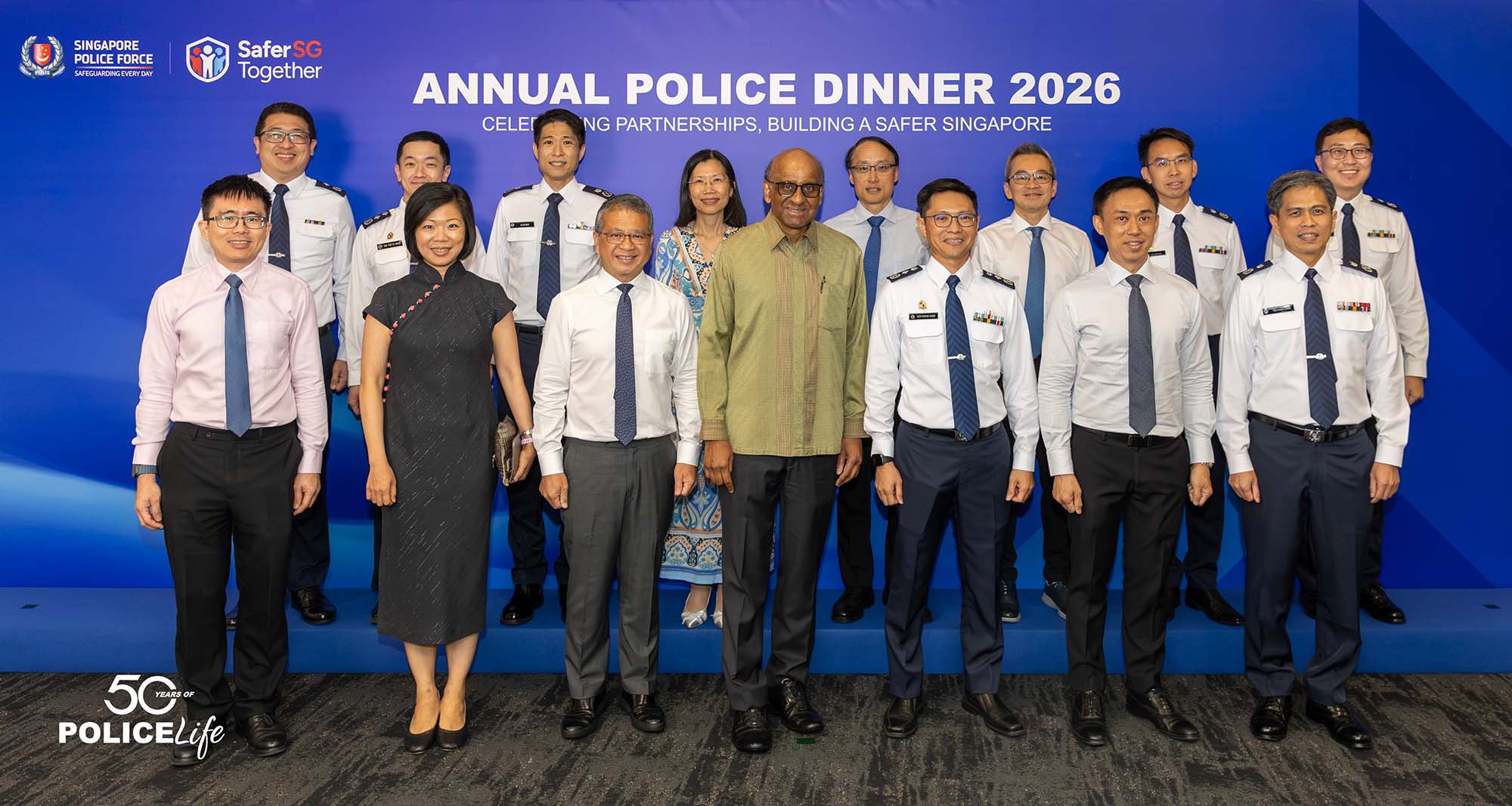 President Tharman posing on stage alongside officers at the Annual Police Dinner 2026. 