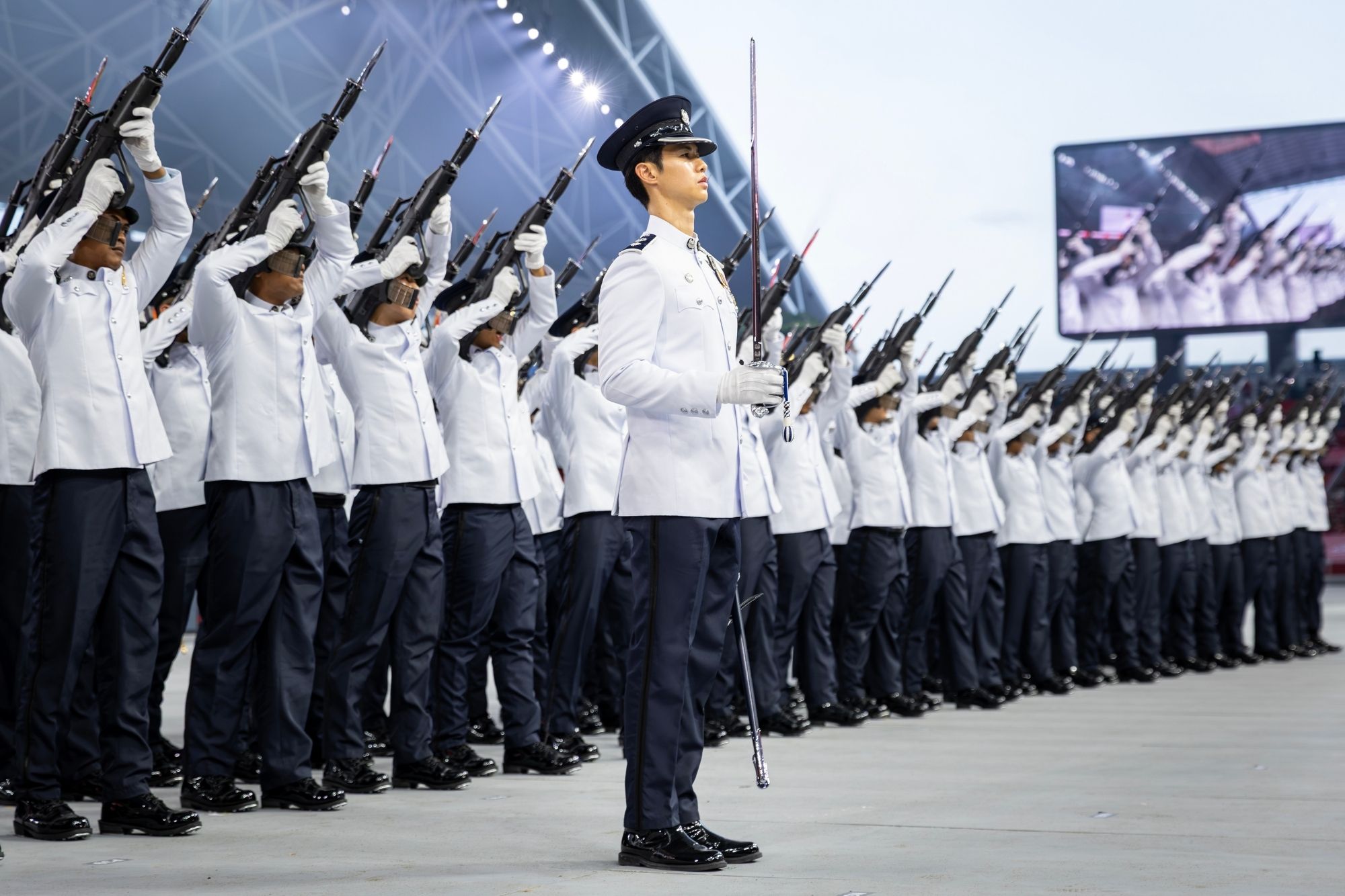 The SPF GOH Contingent executing the Feu de Joie, a celebratory rifle salute. 