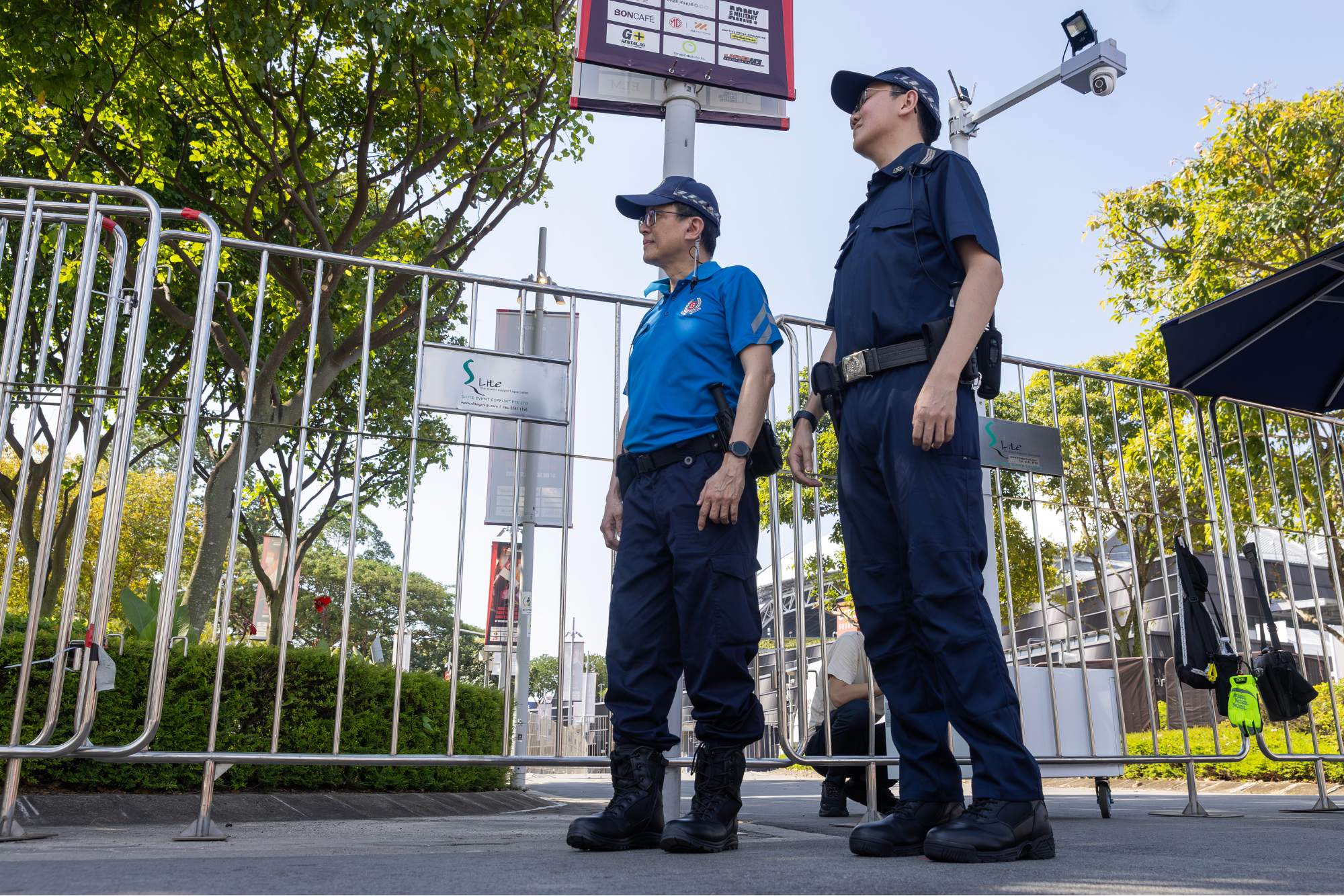 Police officers and volunteers patrolling outside the National Stadium to maintain public order.