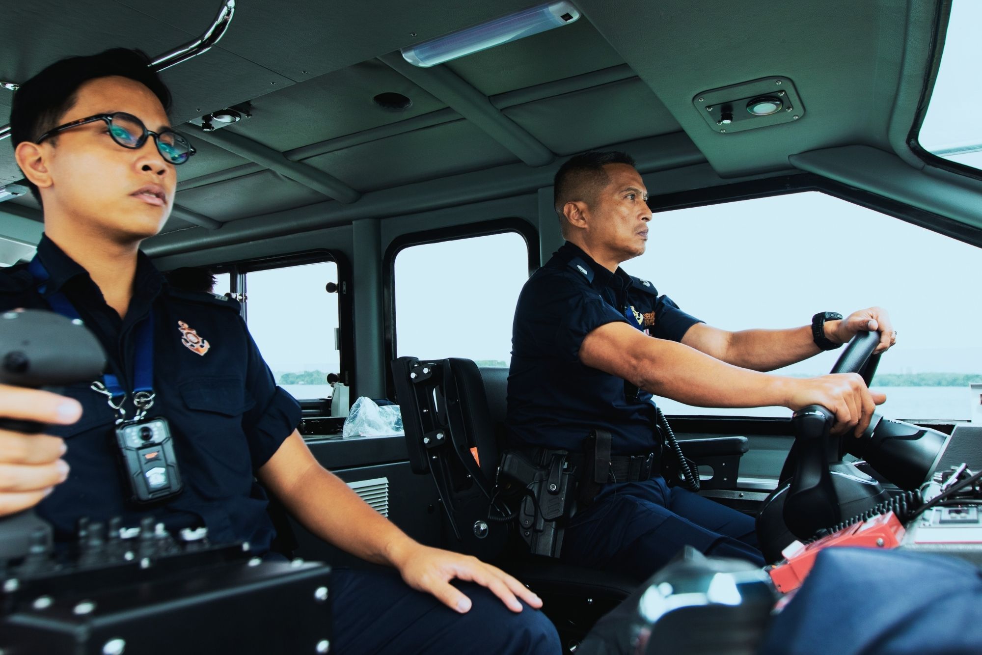 ASP Idzwan steering a vessel with a PCG officer from his team. 