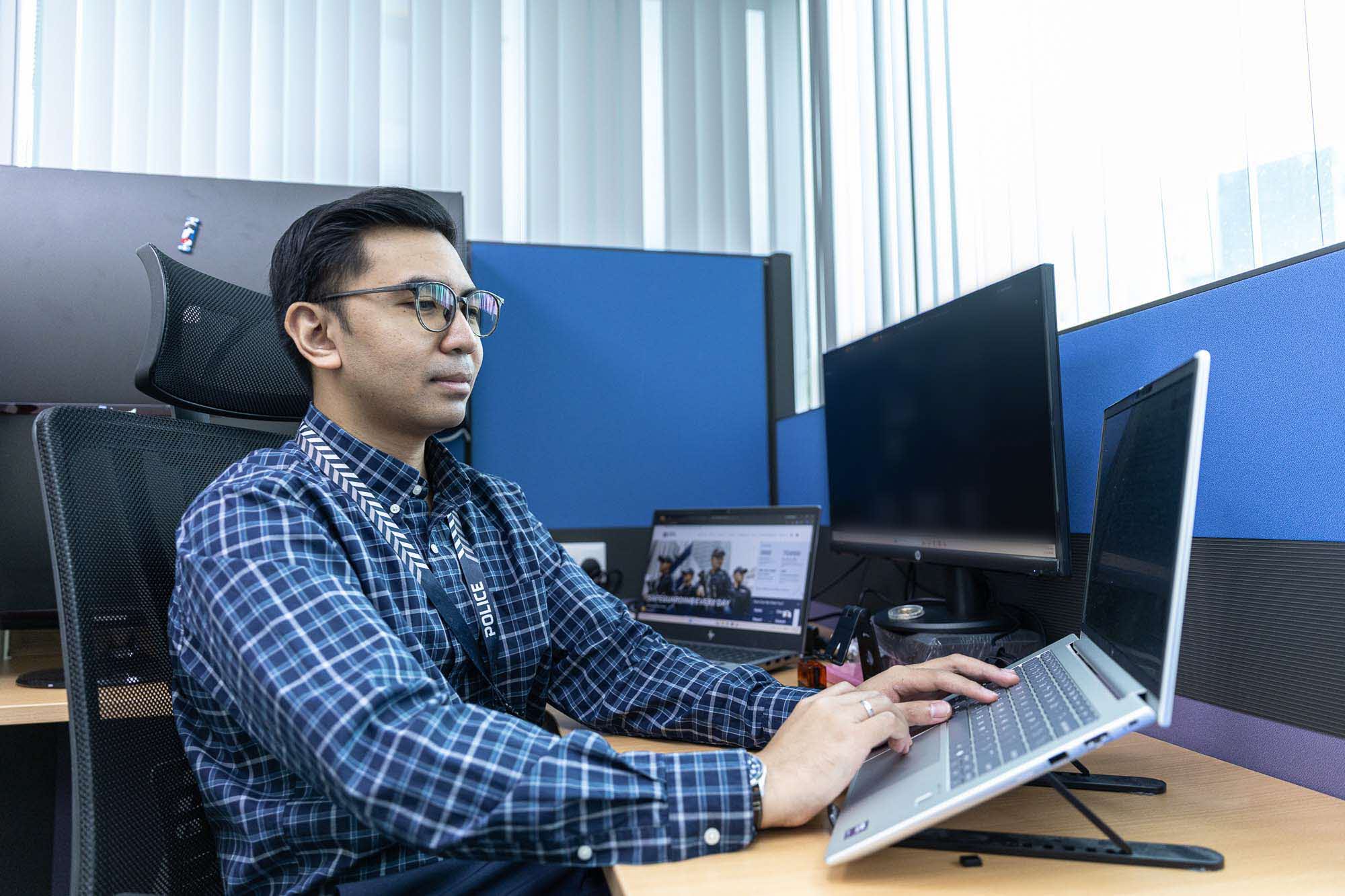 Mr Muhammad Syazwan working at his desk.