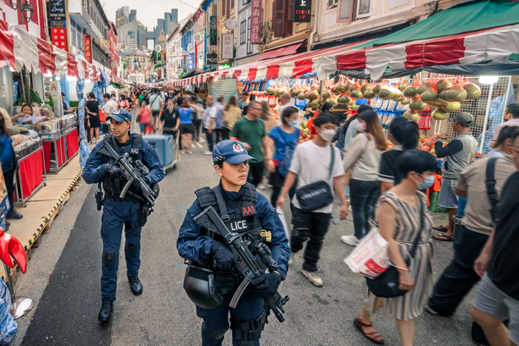 two ert officers walking through crowd in Chinese New Year Bazaar