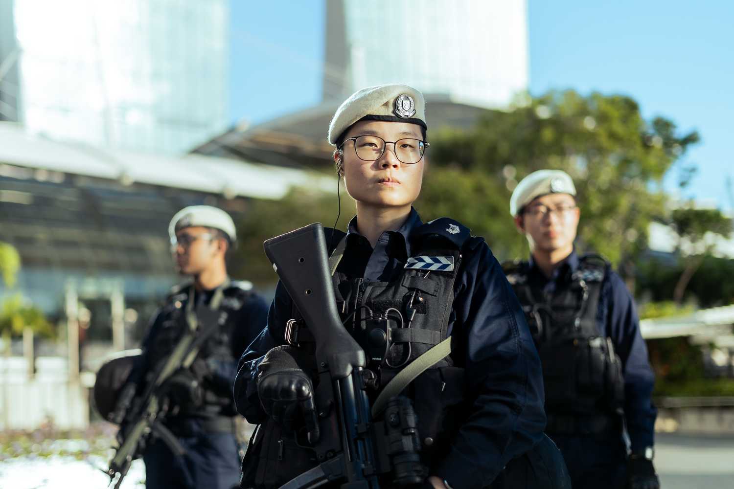 three procom officers standing infront of Marina Bay Sands