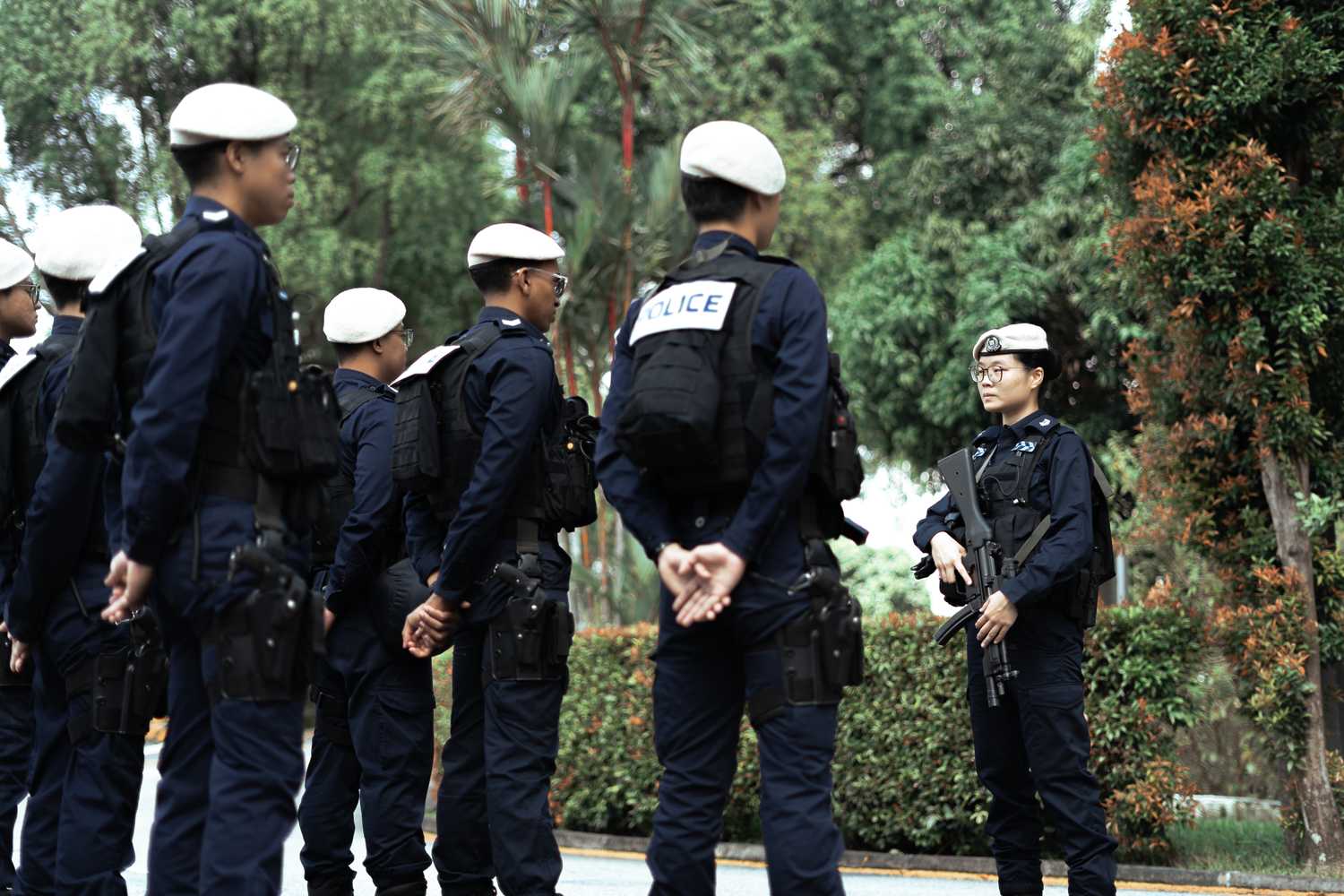 ASP Tan standing infront of IRT national service officers and briefing them